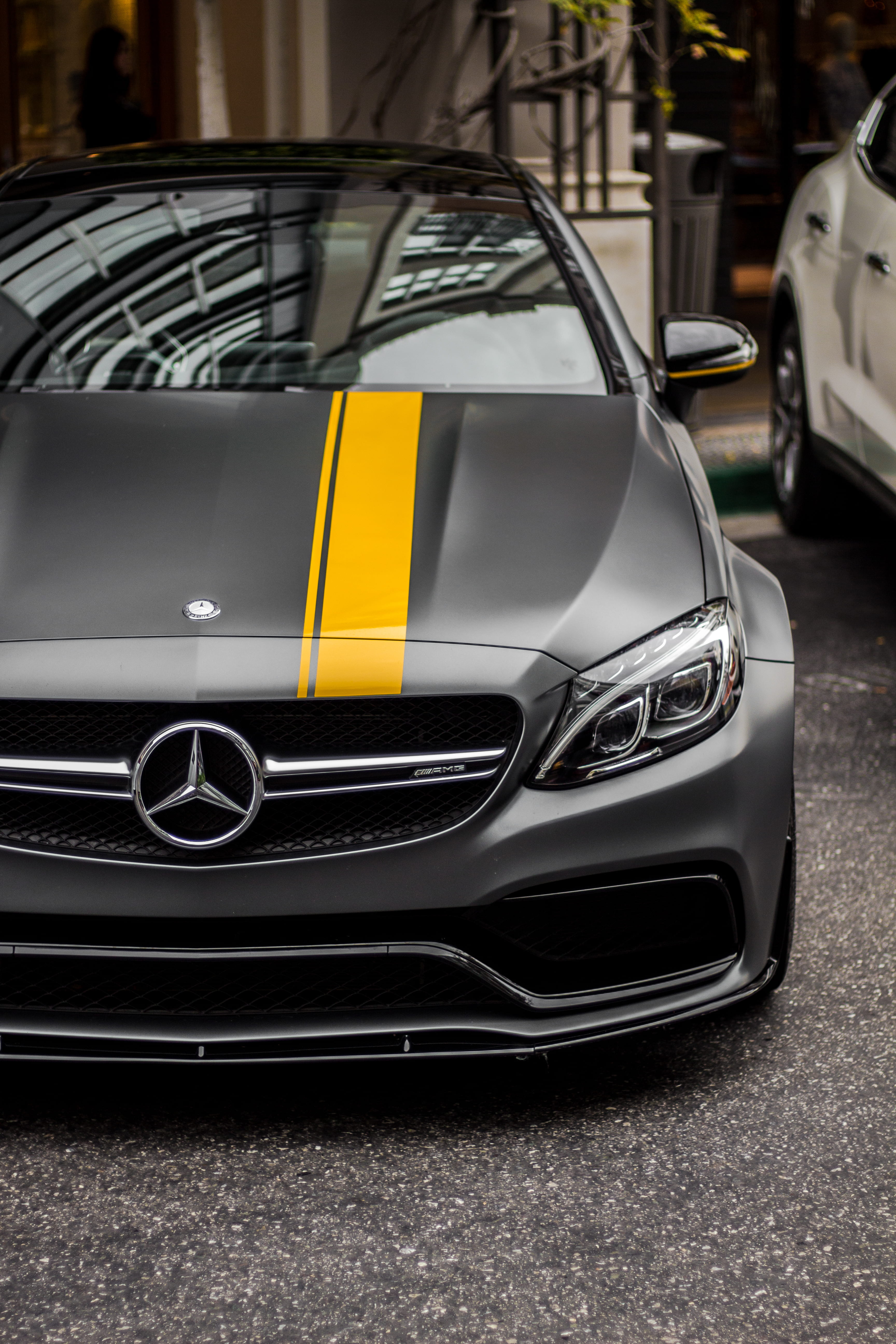 black Mercedes-Benz car, closeup photo of parked matte gray Mercedes-Benz C63 AMG during daytime