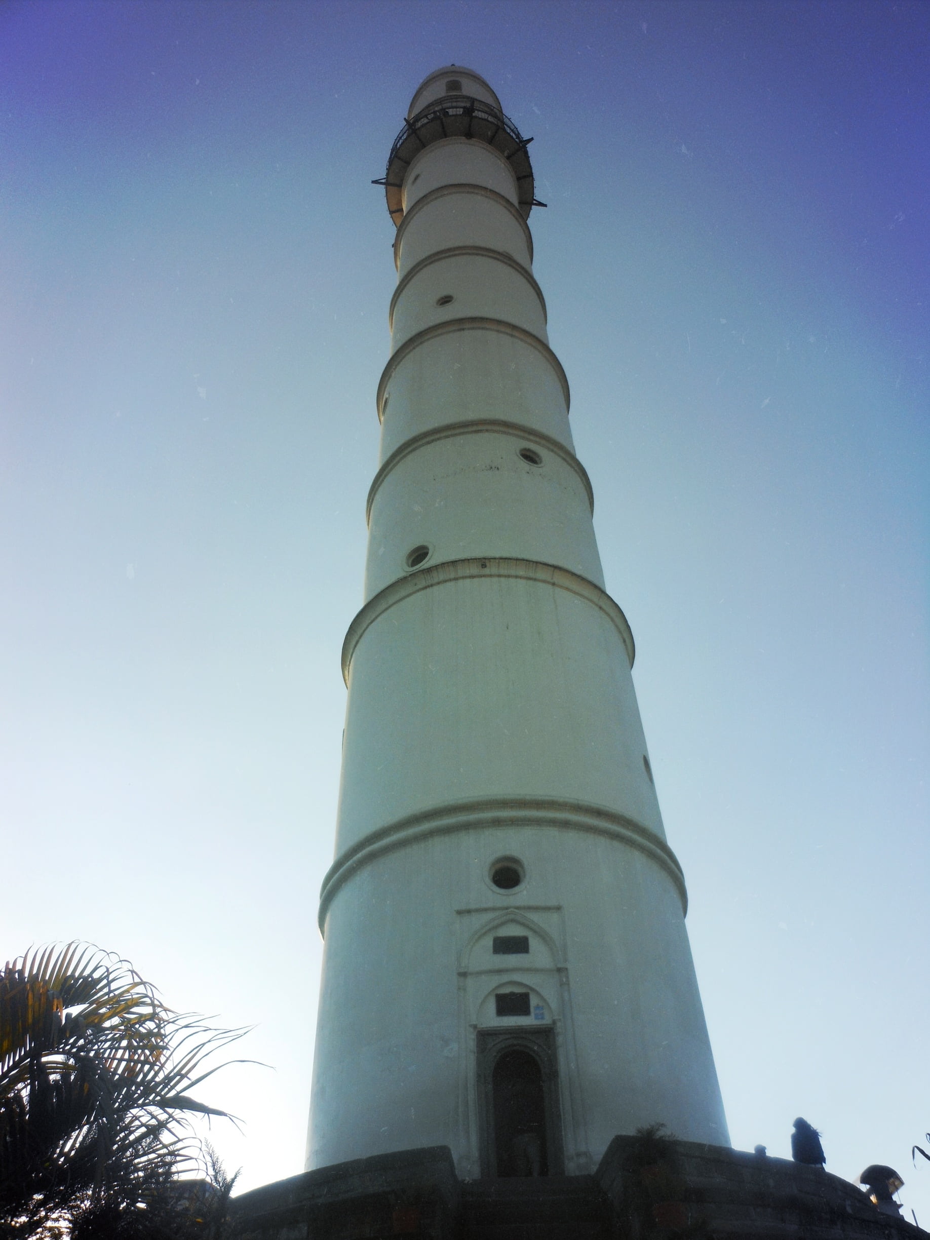 low-angle photography of white concrete lighthouse during daytime