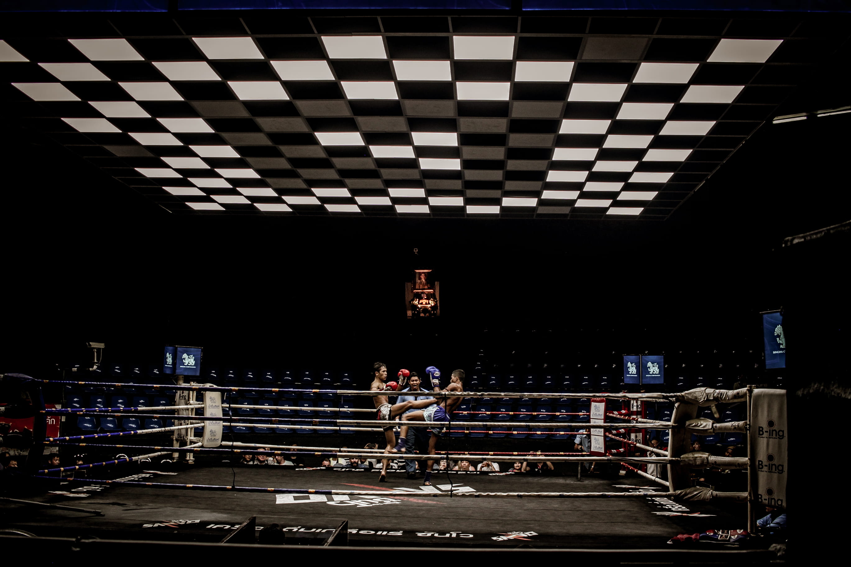 two man in blue and red pair of gloves on boxing ring, two man fighting on square boxing ring