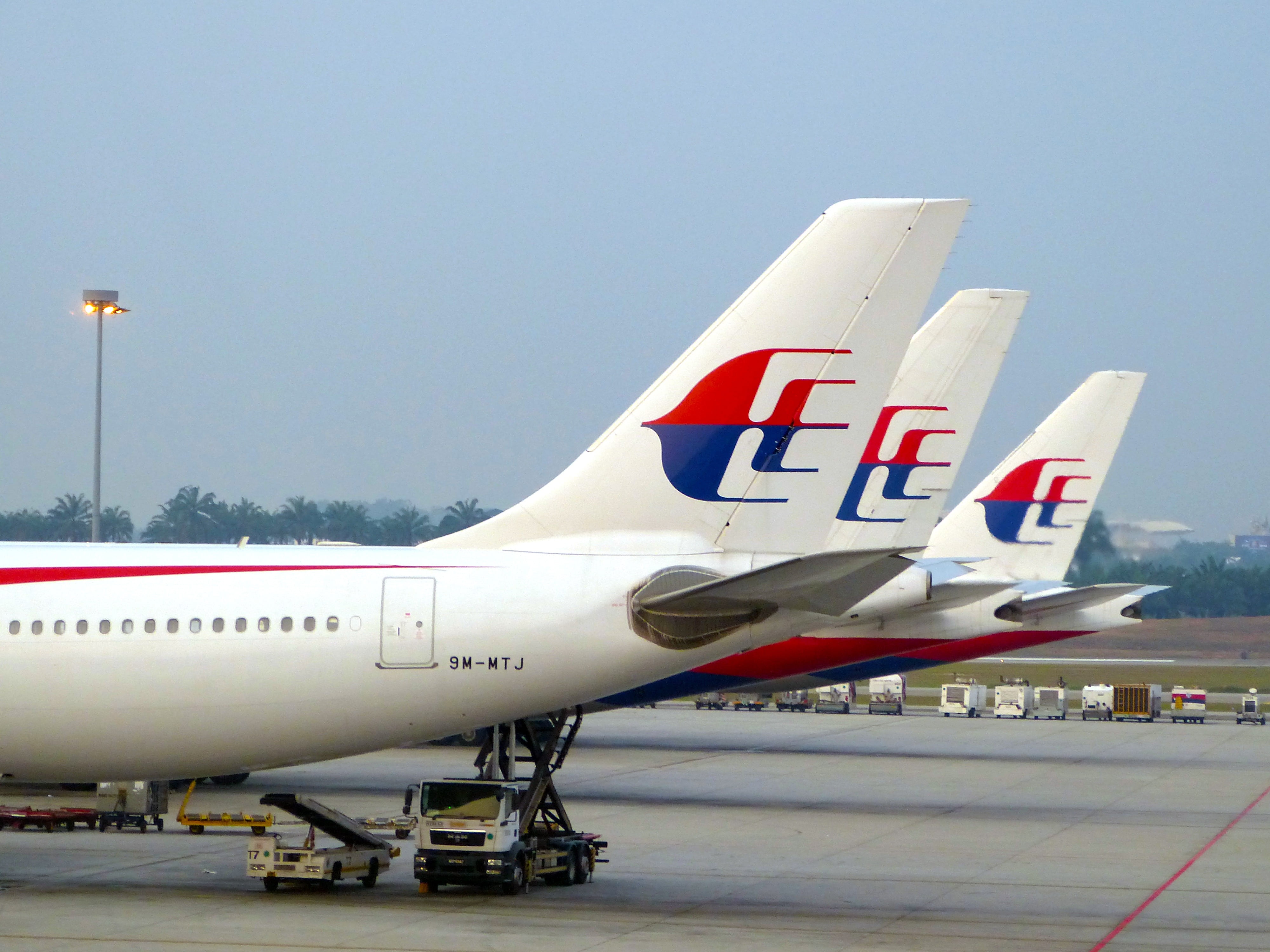 three white-and-red airplanes landing on ground, airline, sky