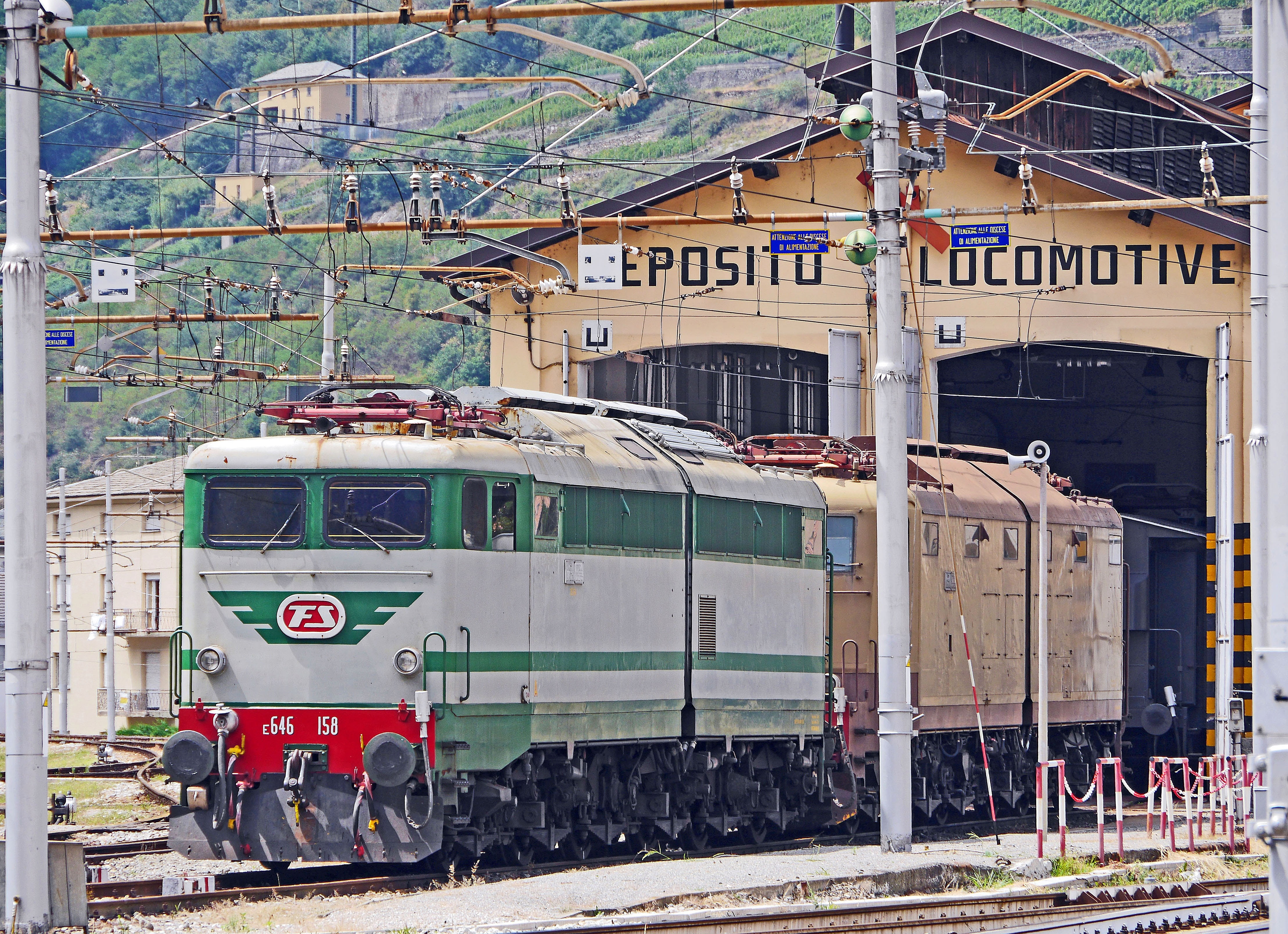 green and gray train in train trail at daytime, electric locomotives