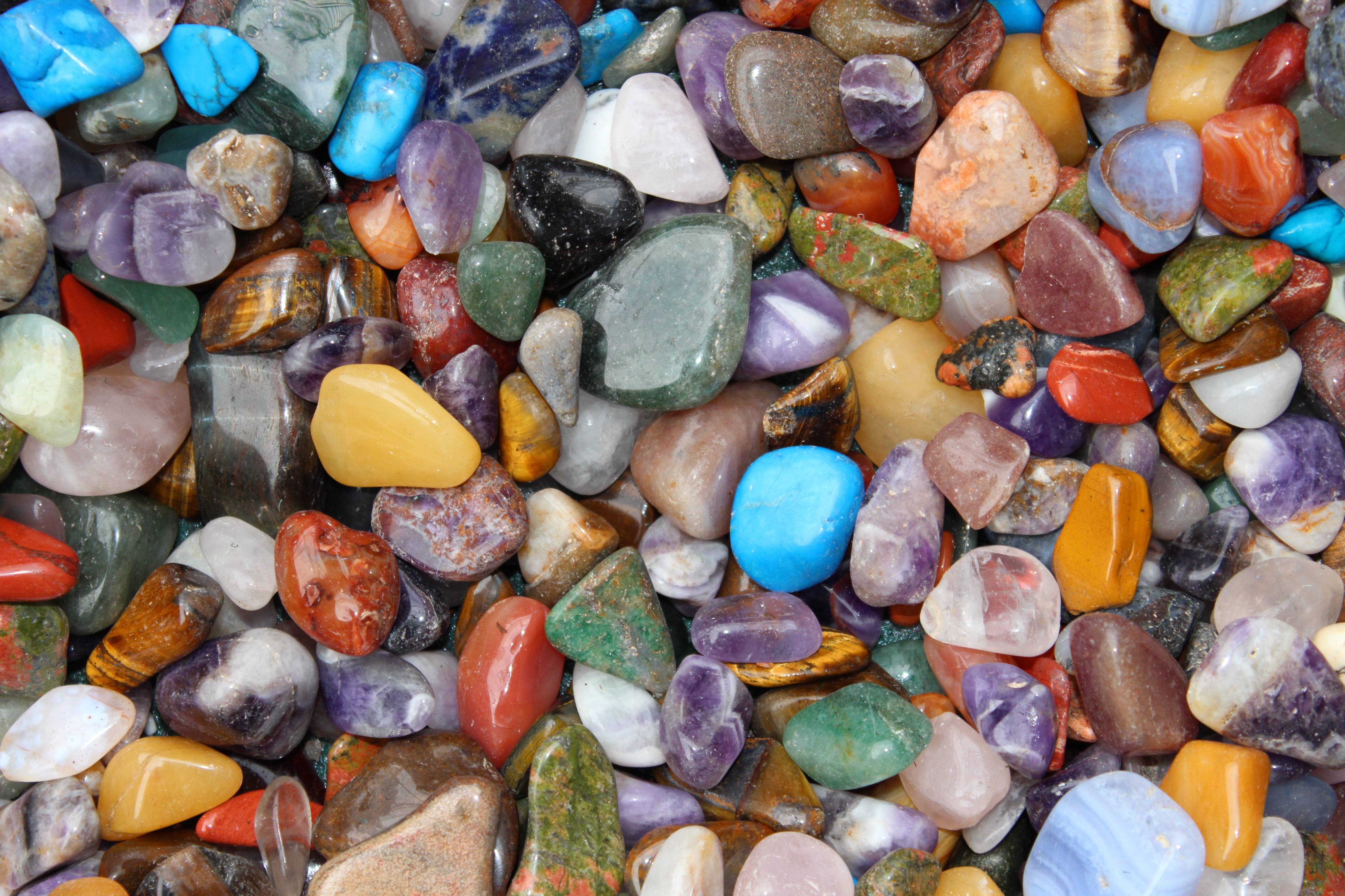 scattered assorted color pebbles, gems, stones, crystal, gemstone