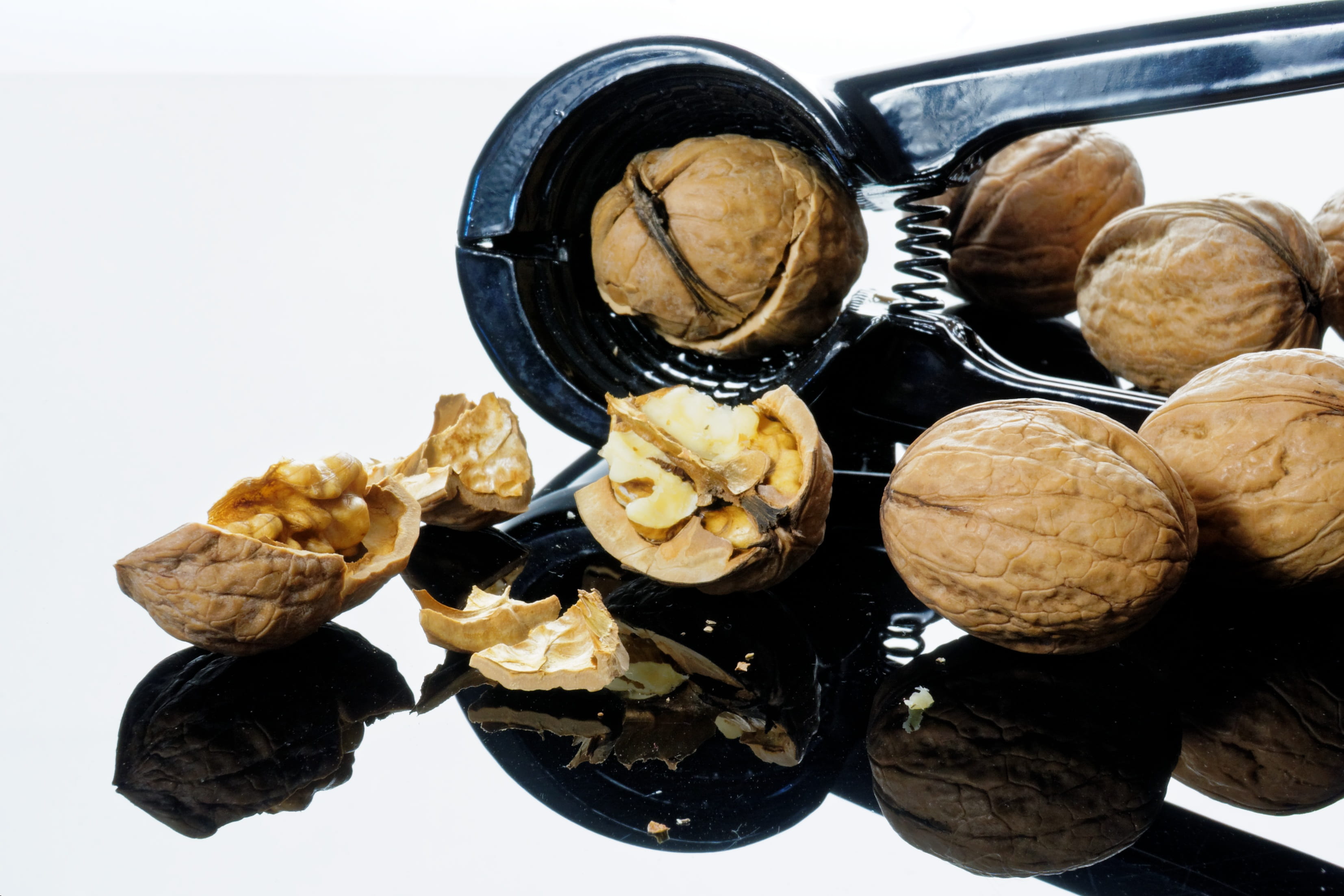 walnuts cracked using nutcracker, nutshells, christmas time, breaking up
