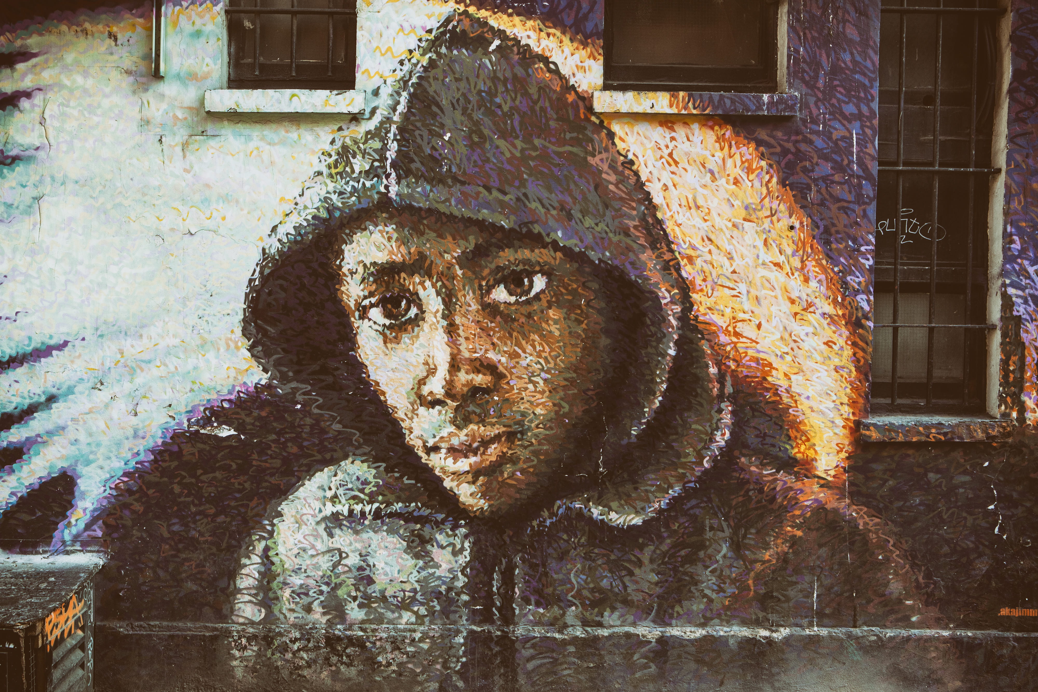 Street Art depicting a man wearing a hoodie top, urban, graffiti