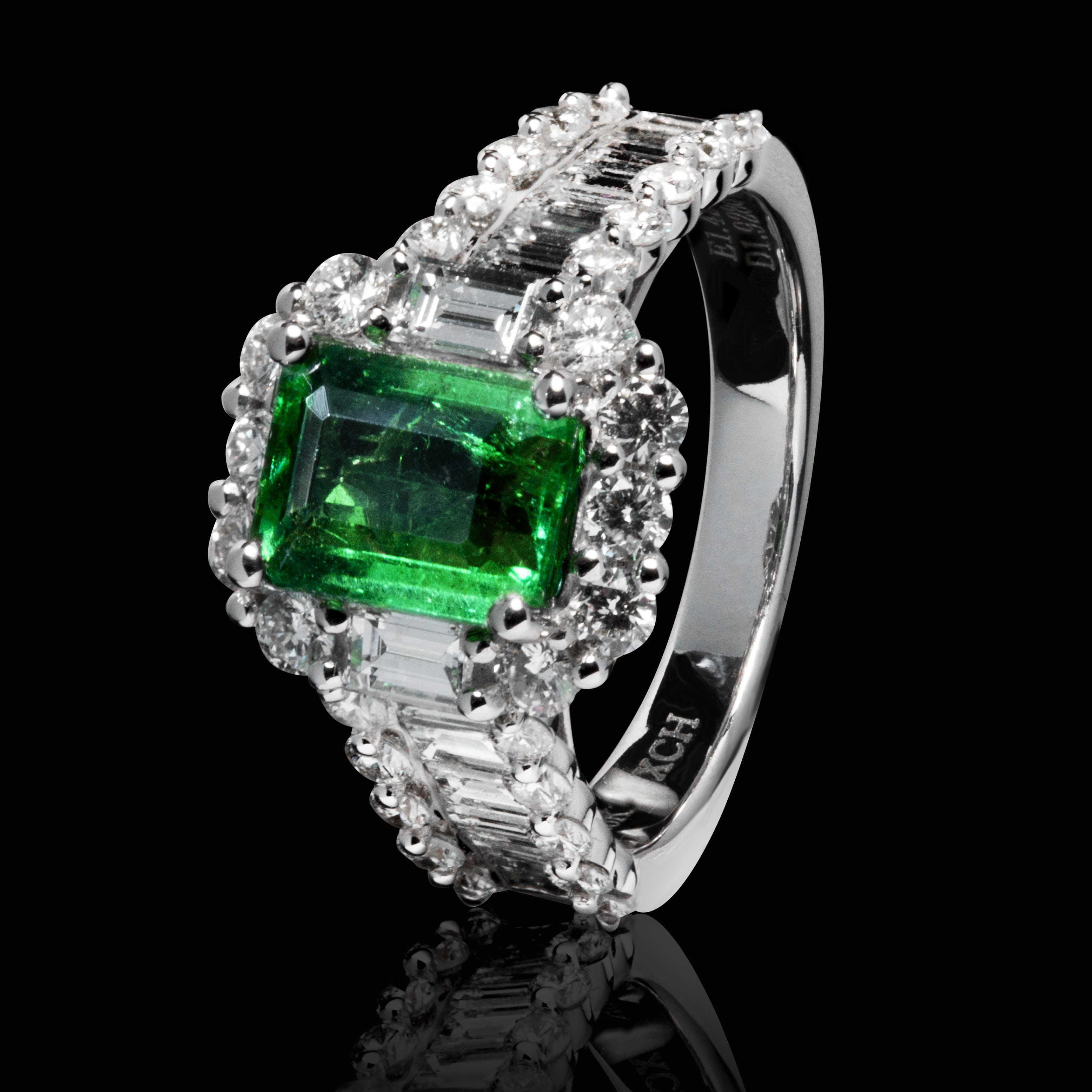 silver-colored ring with clear and green gemstones, emerald, luxury