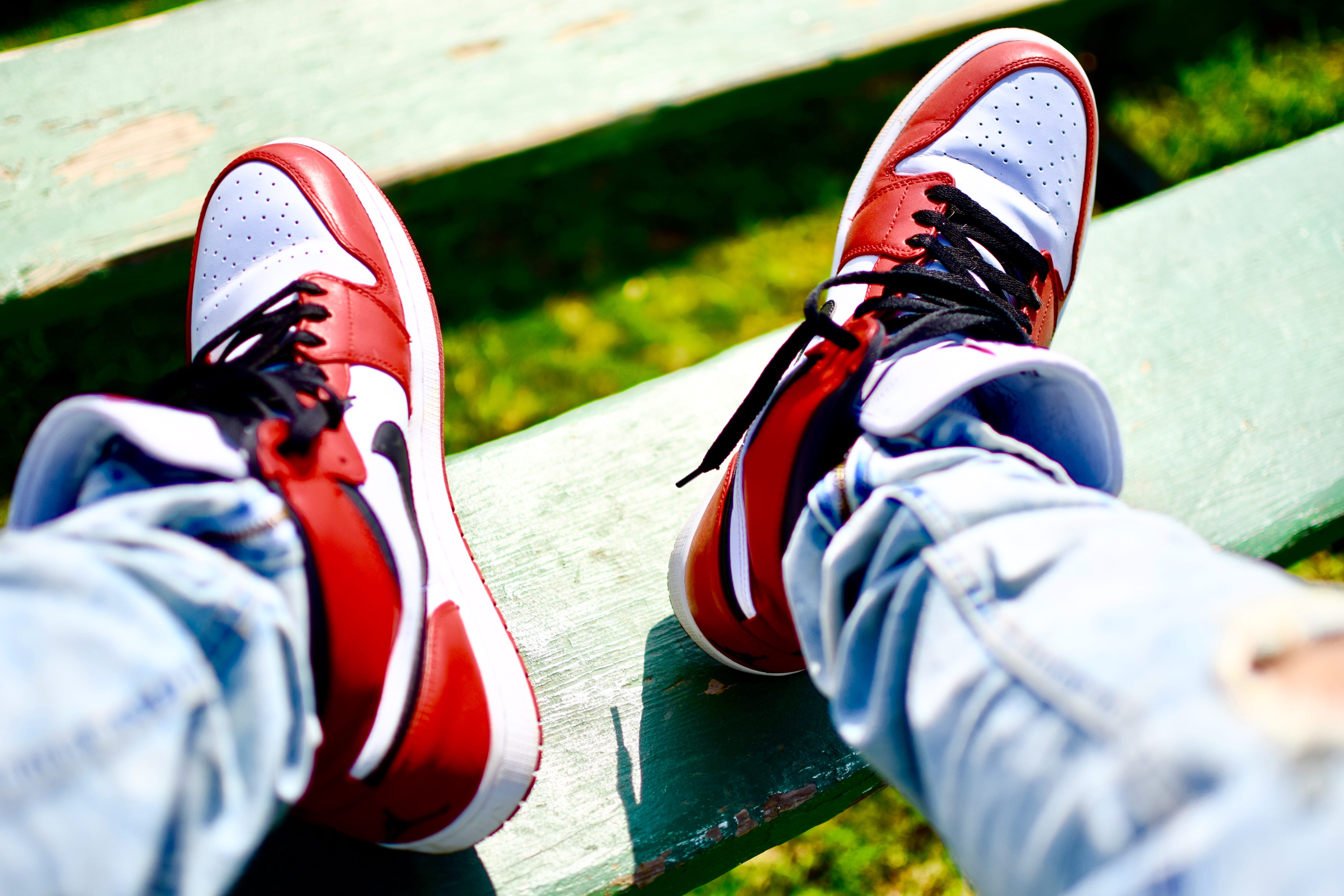 Kicks and Clicks, person wearing red-white-and-black Nike high-top sneakers