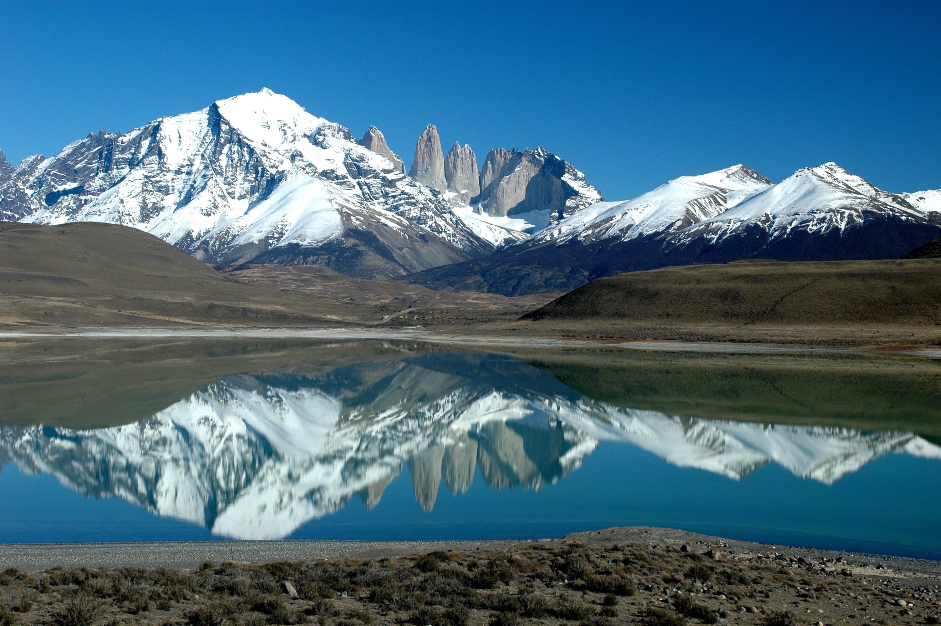 snow covered mountain near body of water, patagonia, fitz roy