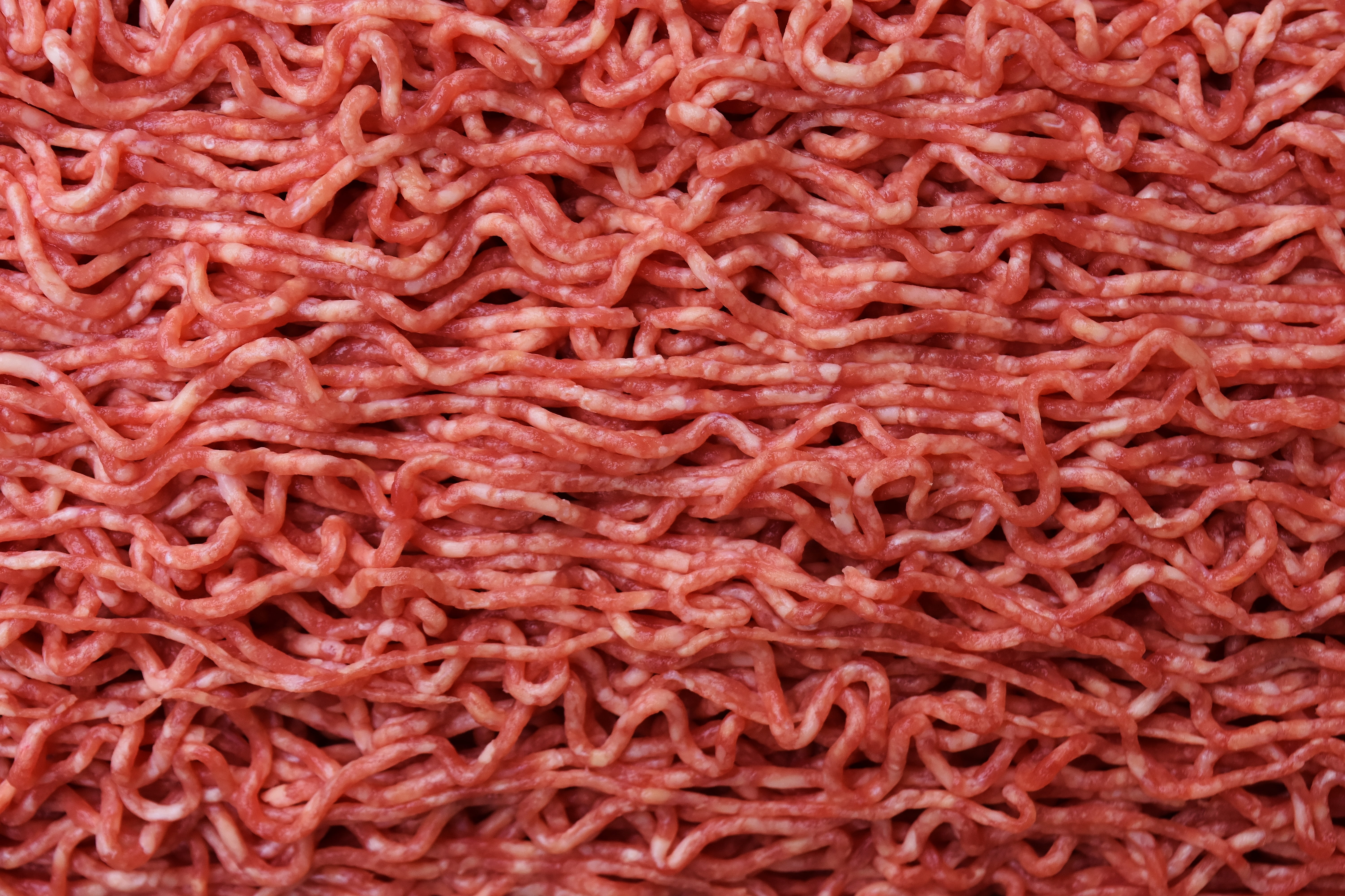 close-up photo of red noodles, minced meat, minced ' meat, raw