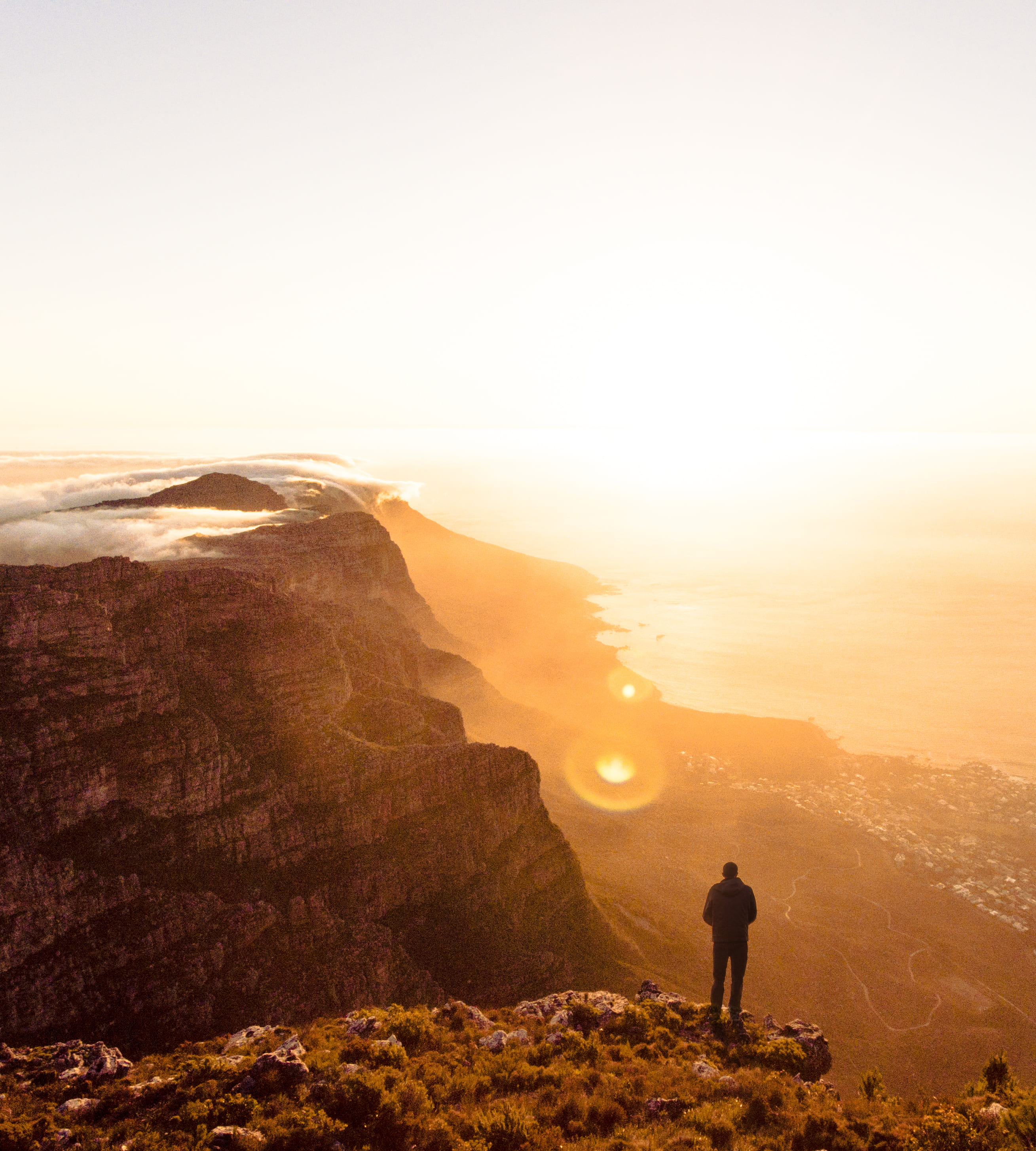 On the edge., man standing on mountain cliff, person, landscape