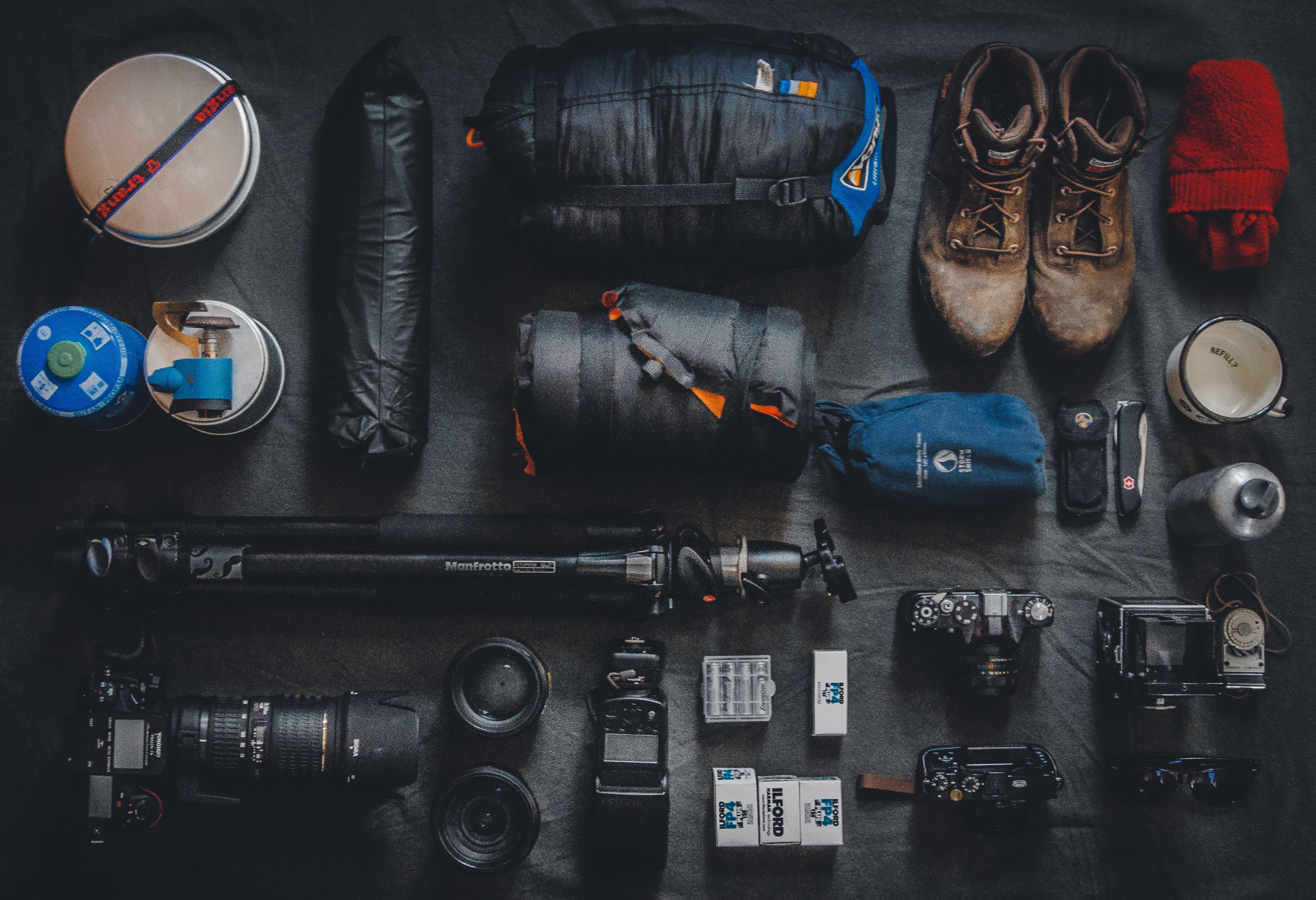 photo of assorted cameras and bags, flat lay photography of camera and camping kits