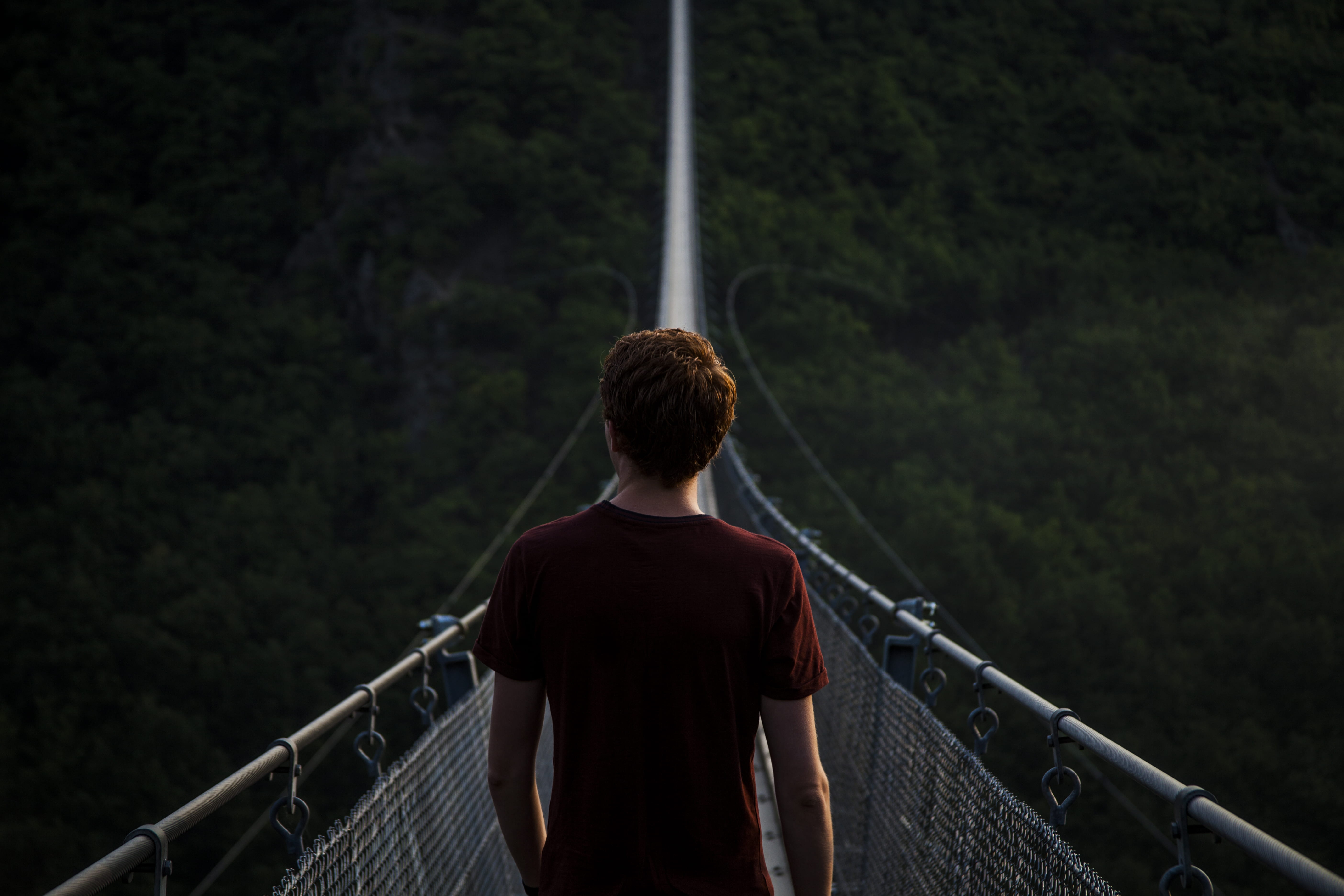 man standing alone on hanging bridge, man on hanging bridge at daytime
