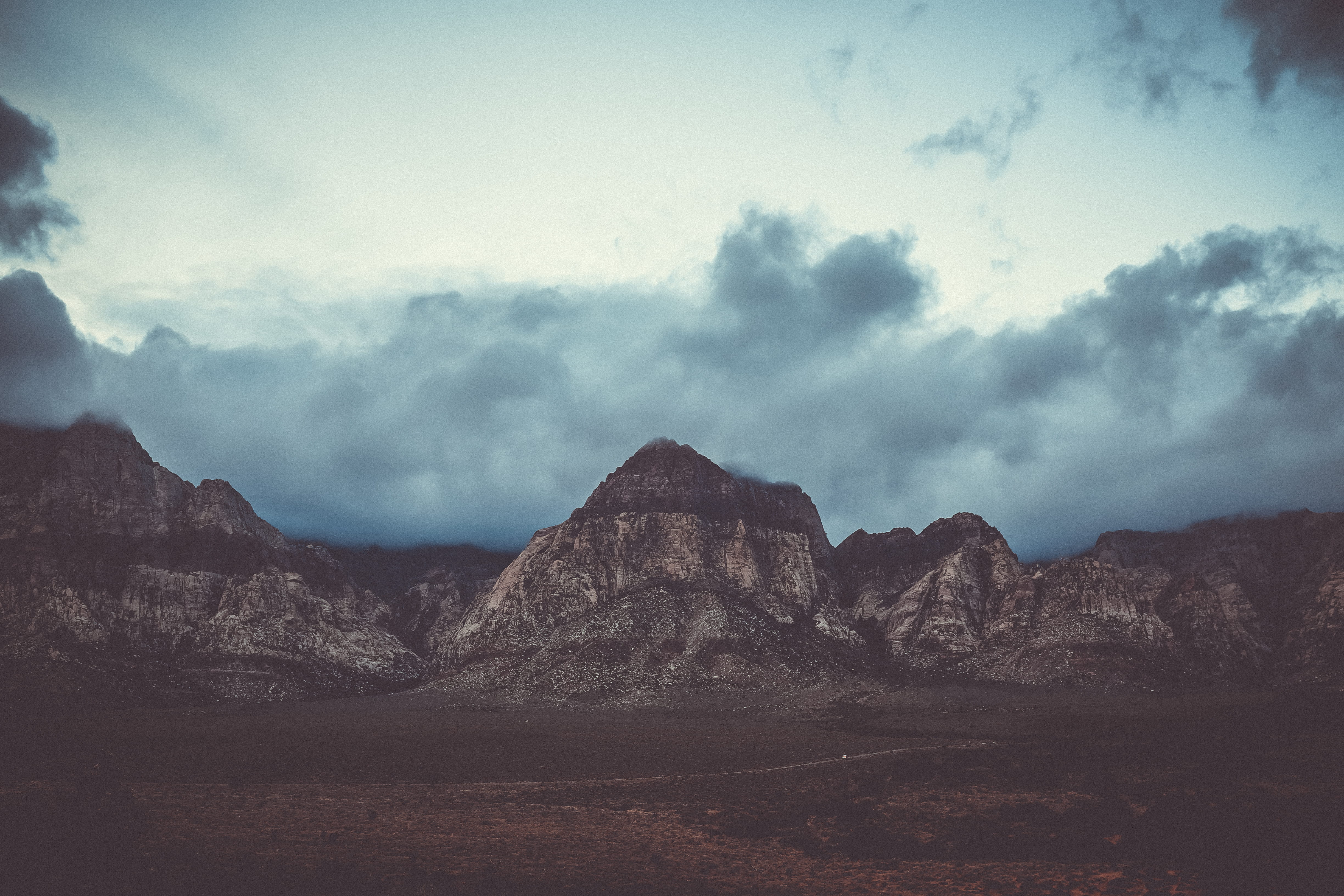 Red Rock, gray stone formation range under cloudy sky, mountain