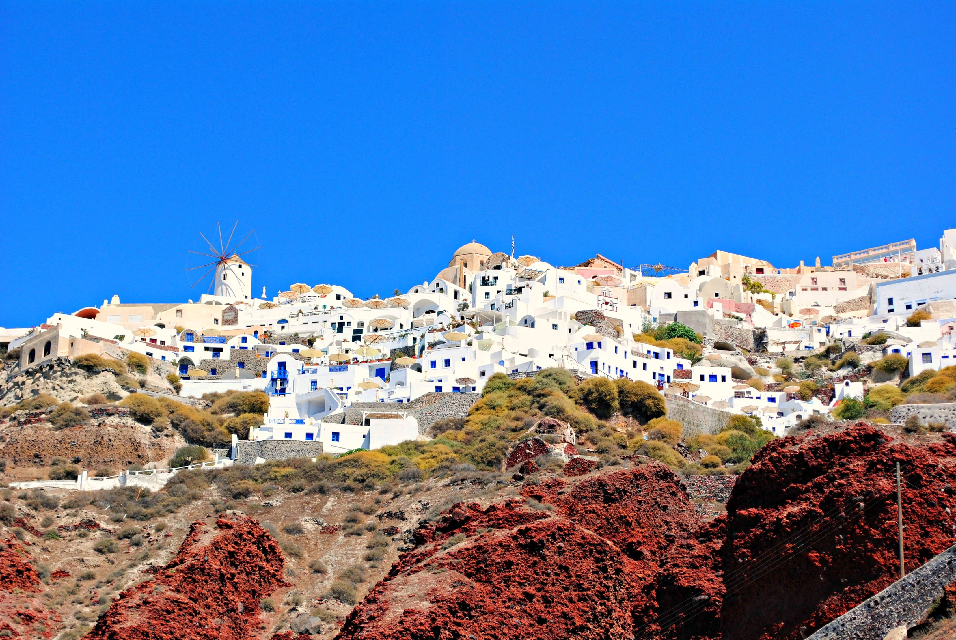 white painted houses under clear blue sky, ammoudi, beach, santorini