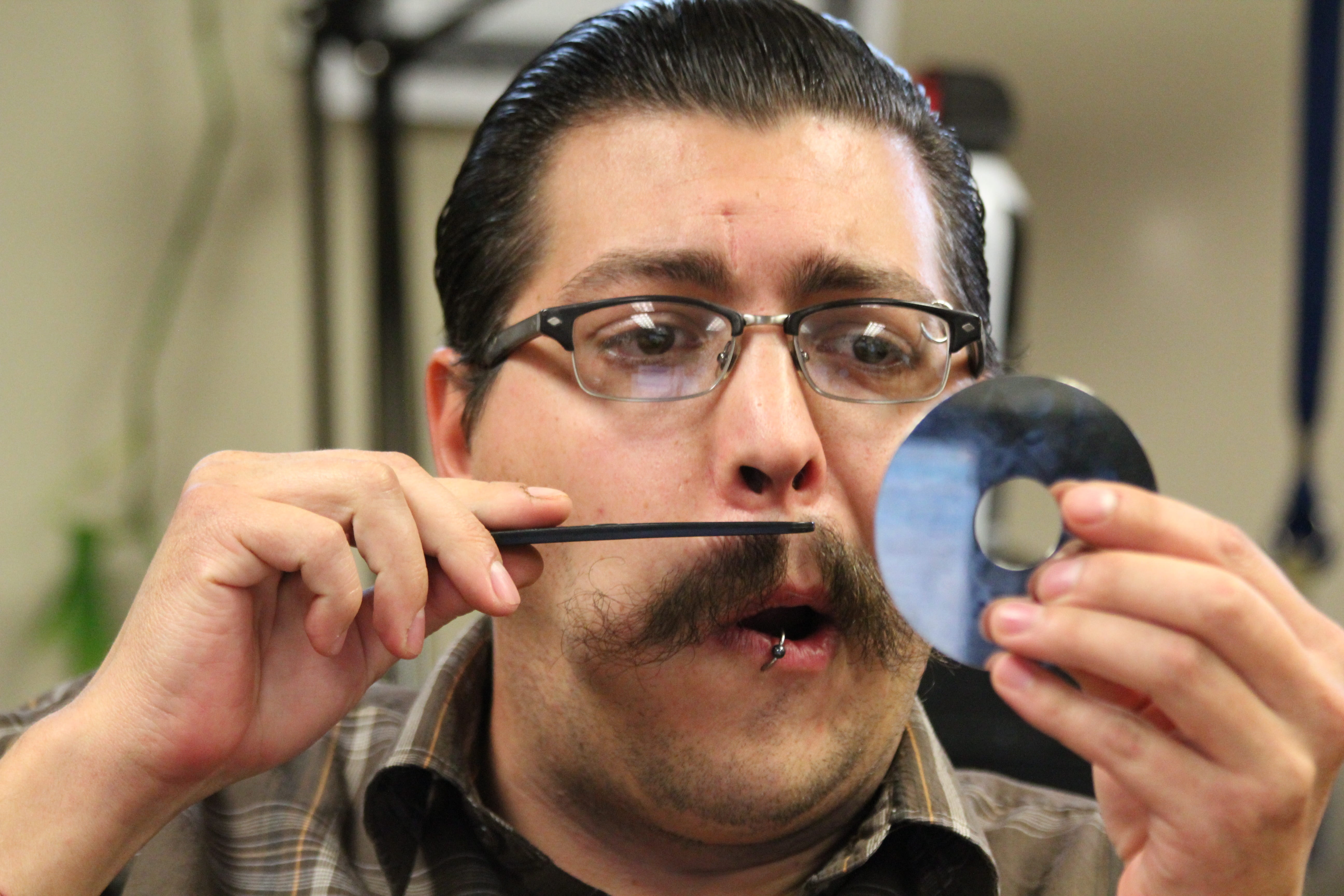 man trimming his beard at daytime, cd, reflective, disk, dvd