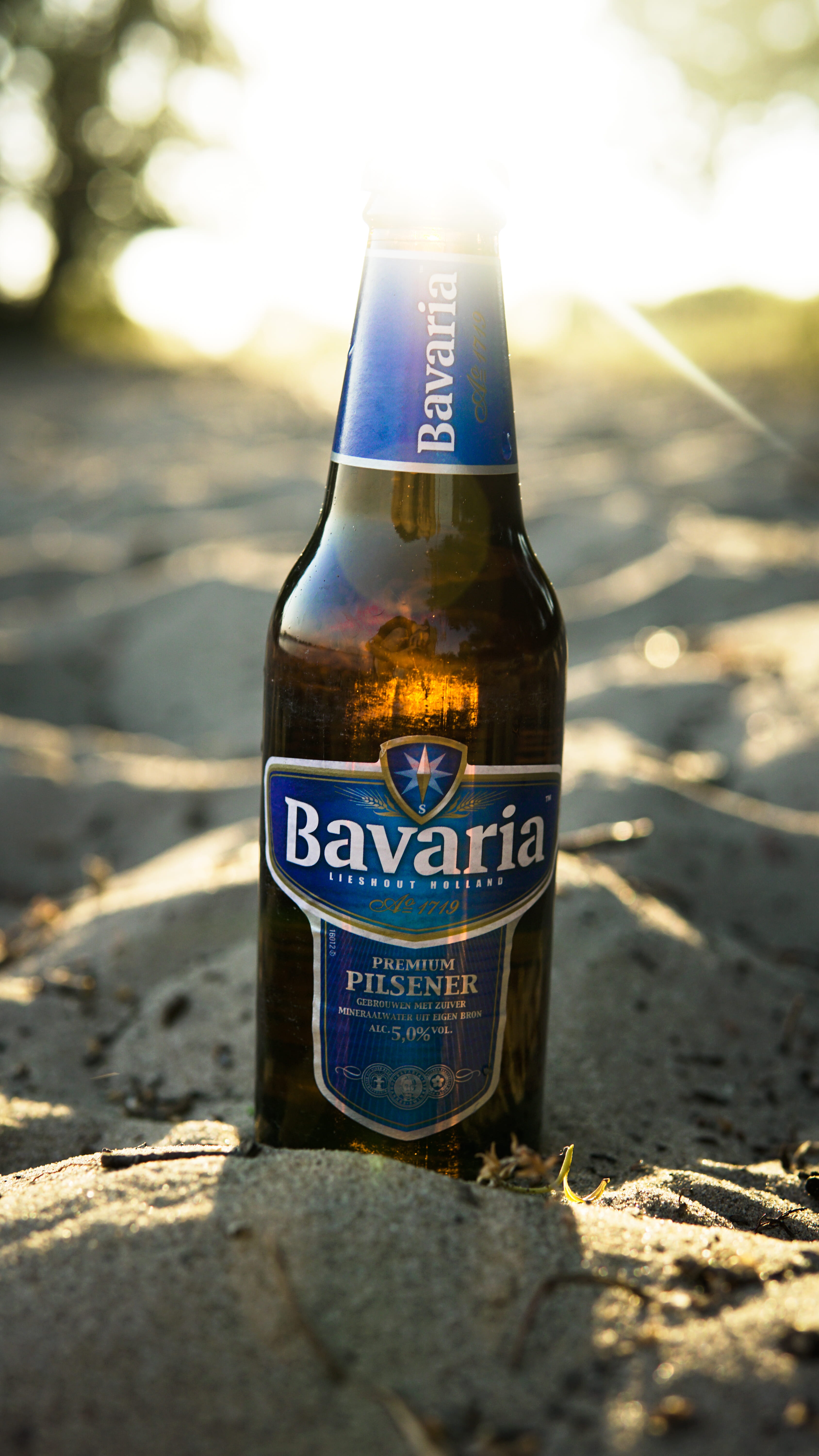 Bavaria Pilsener beer bottle on sand, Bavaria premium Pilsner bottle