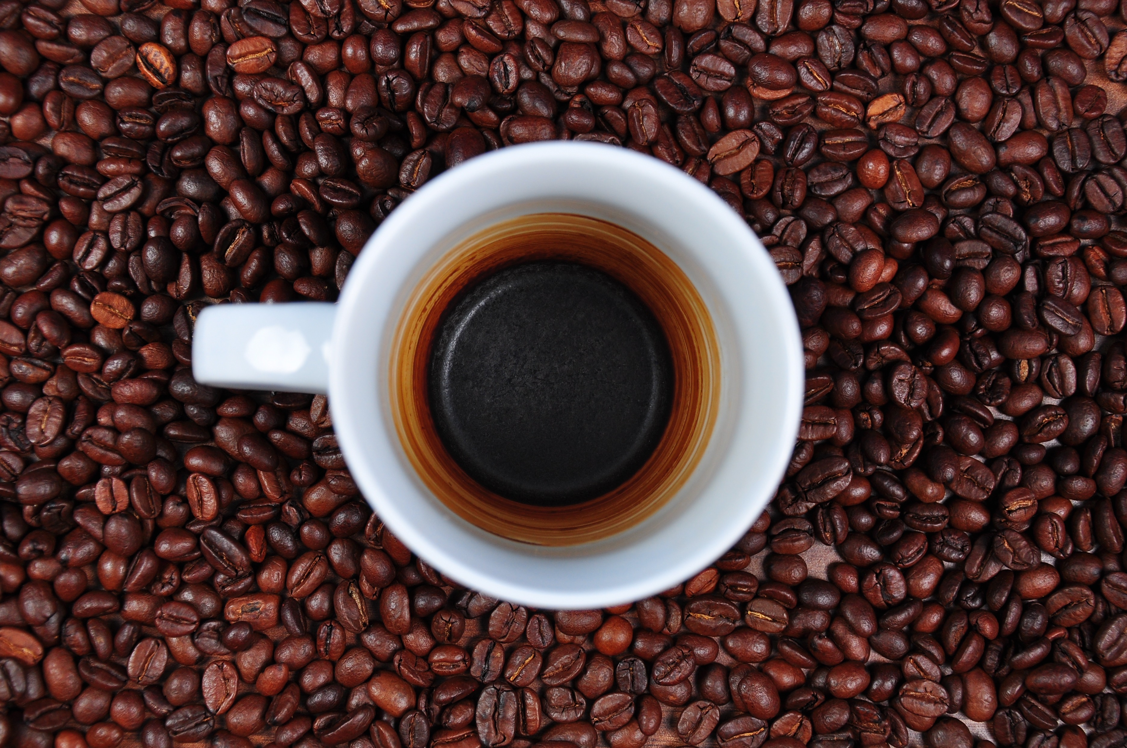 white ceramic mug with black coffee, empty cup, coffee beans