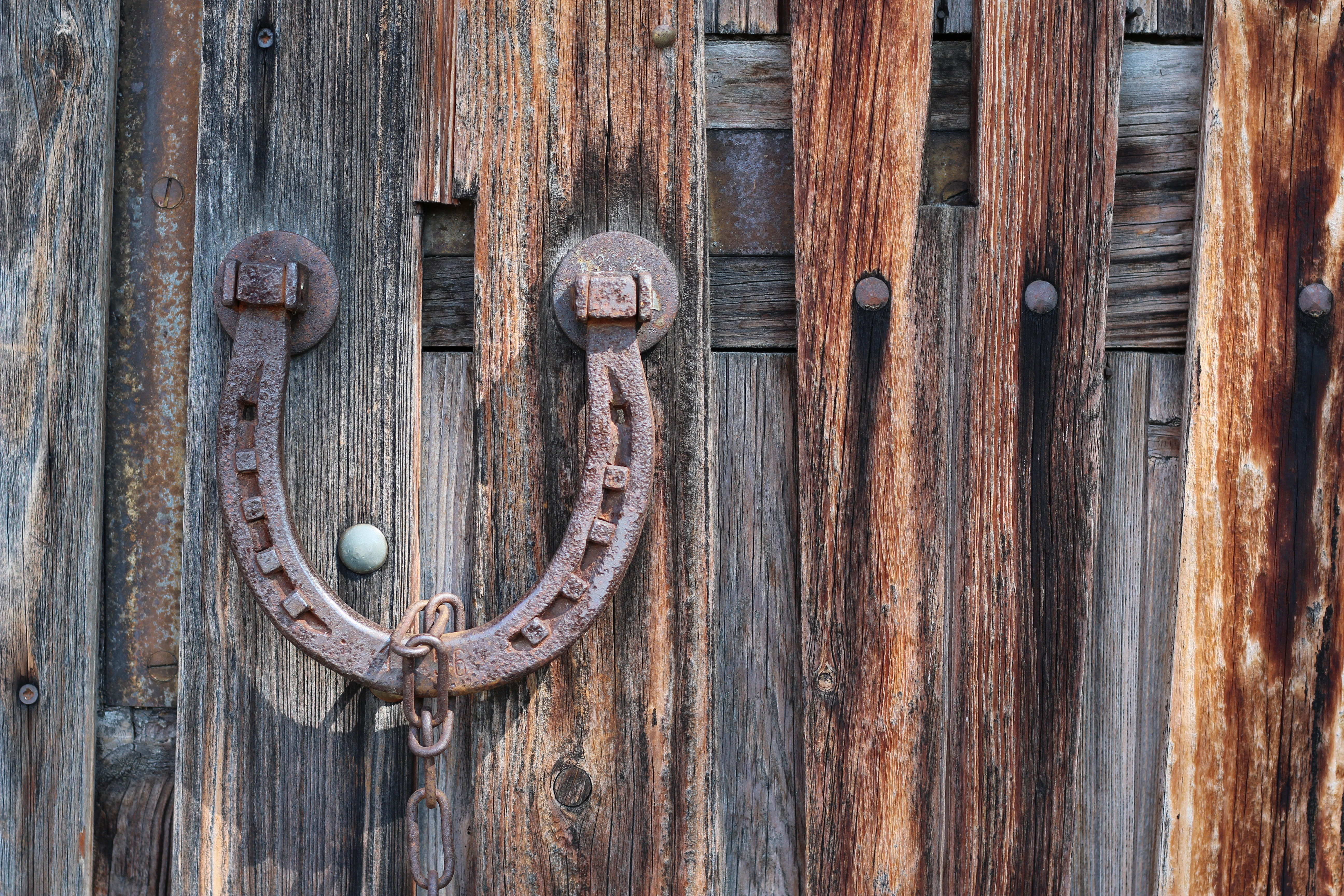 brown steel horse shoe kob, horseshoe, goal, barn, wood, door