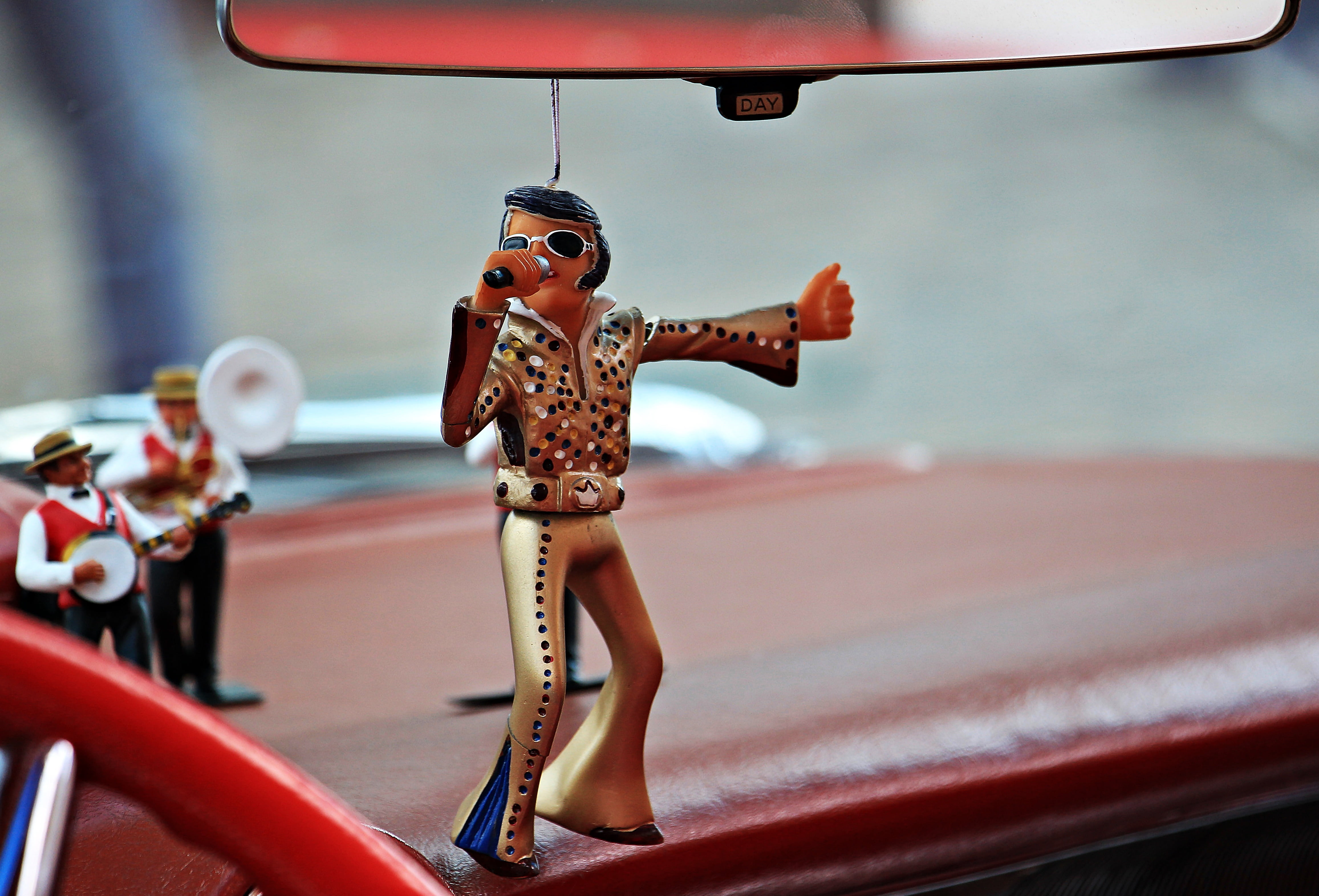 selective focus photography of Elvis Presley ornament hanging on rear view mirror