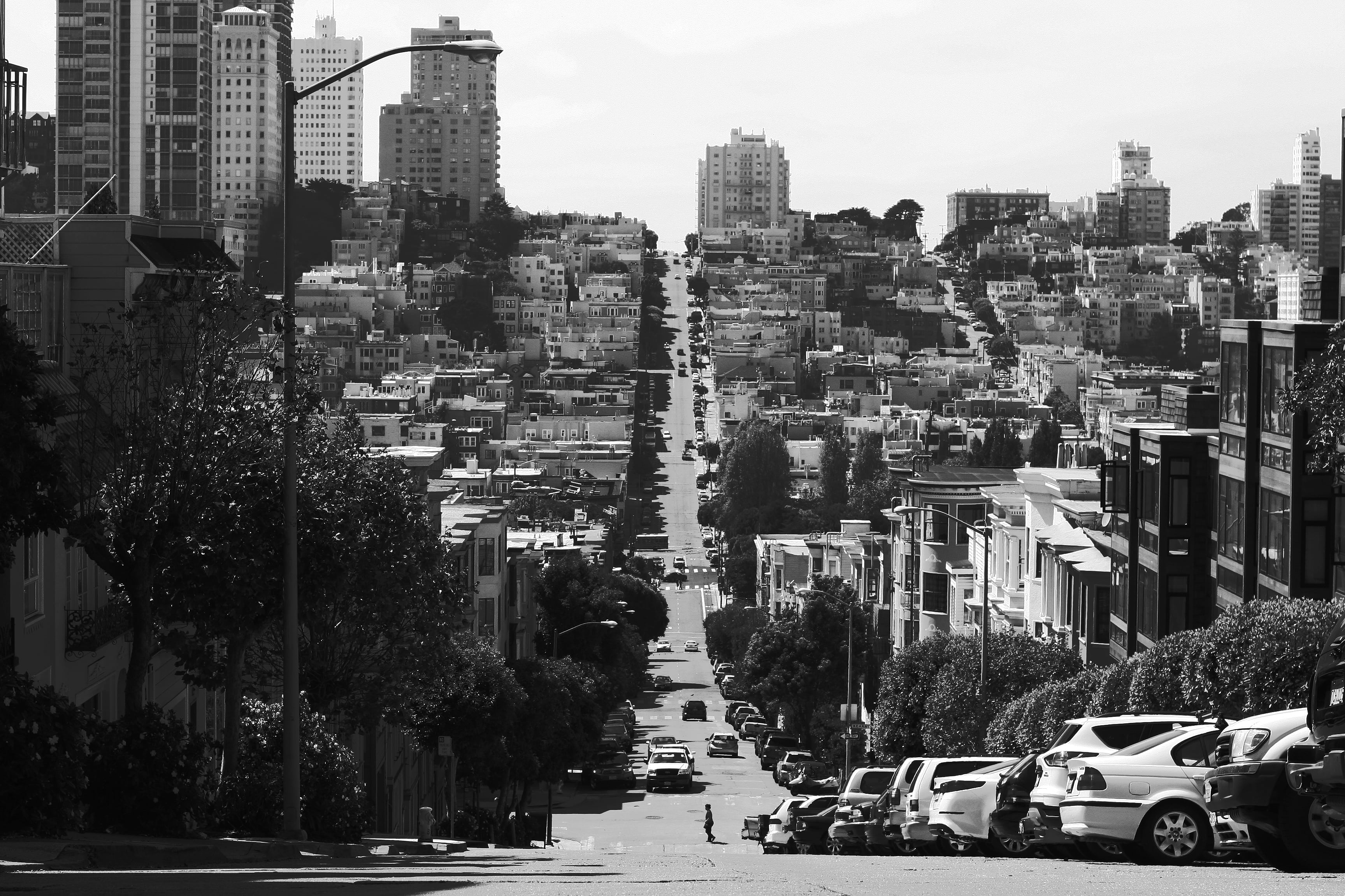 grayscale photography of city, street, road, urban, hill, cars