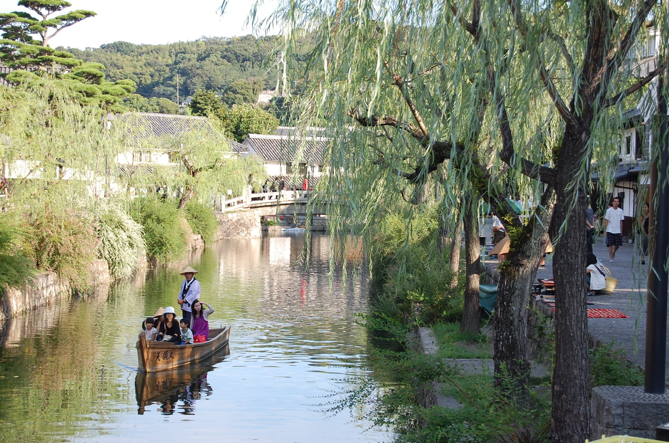group of person riding on brown row boat, Kurashiki, Okayama