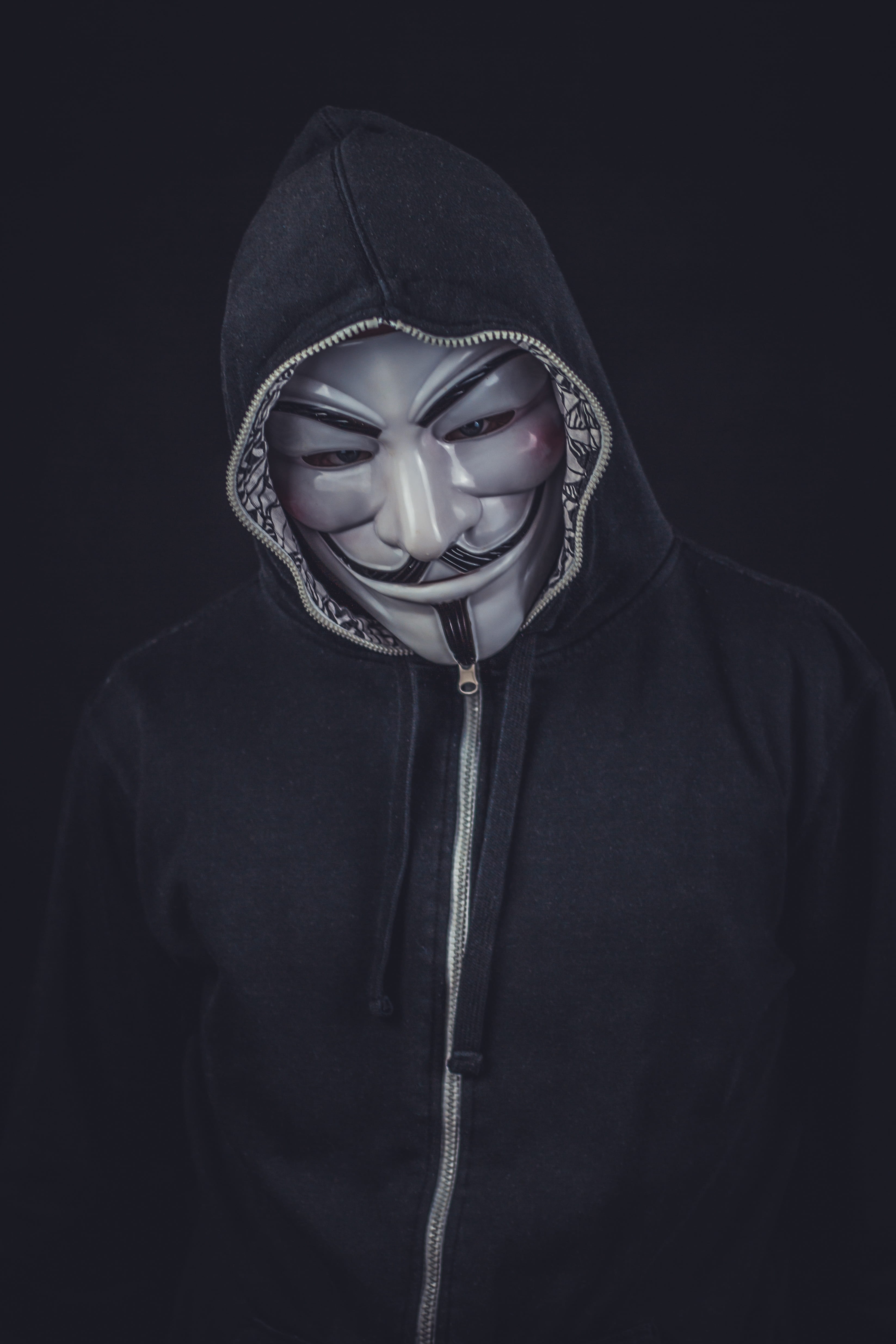 person wearing seafawk mask and black zip-up hoodie, v for vendetta