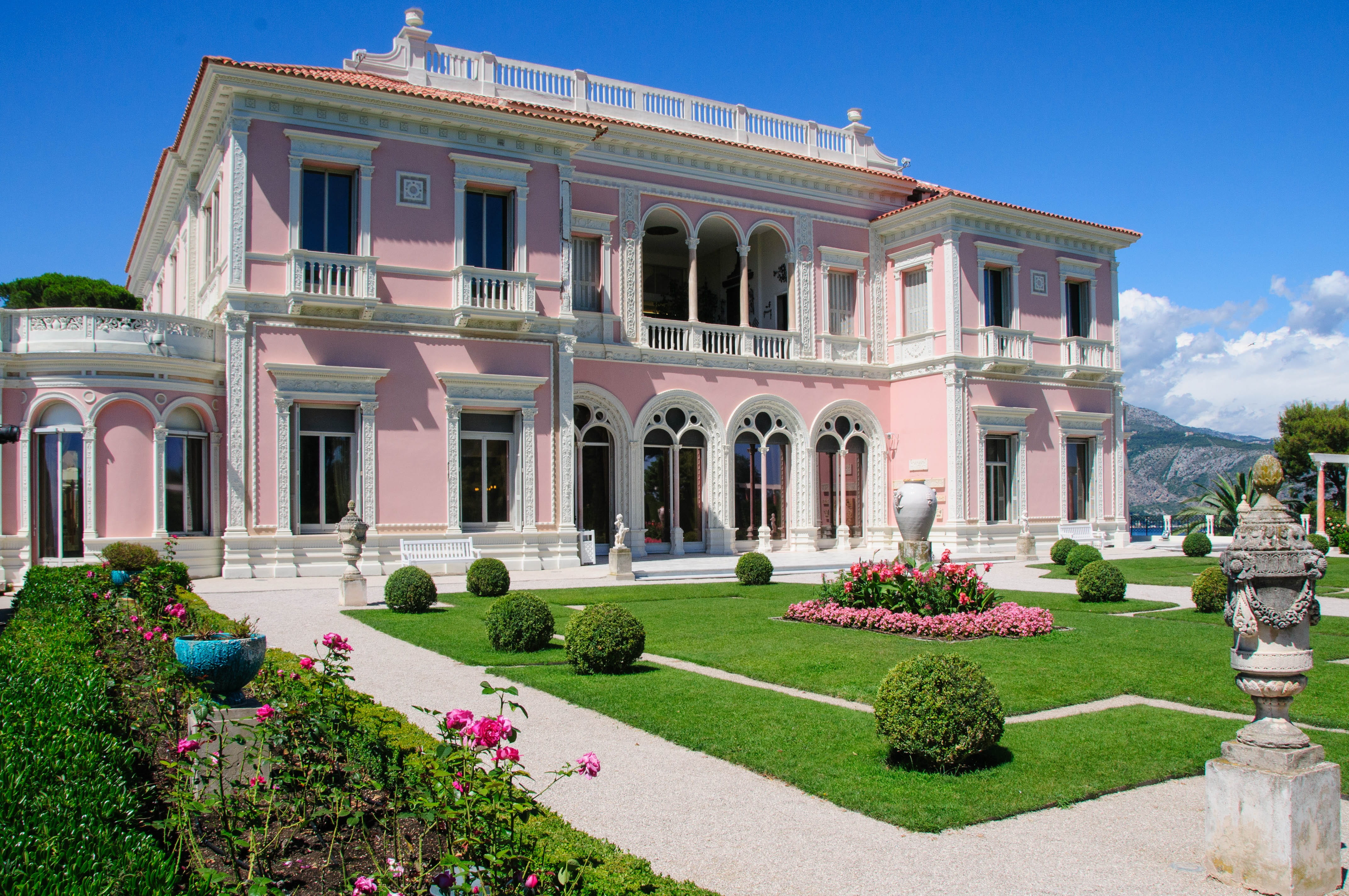 photo of pink and white painted house at daytime, villa, ephrussi