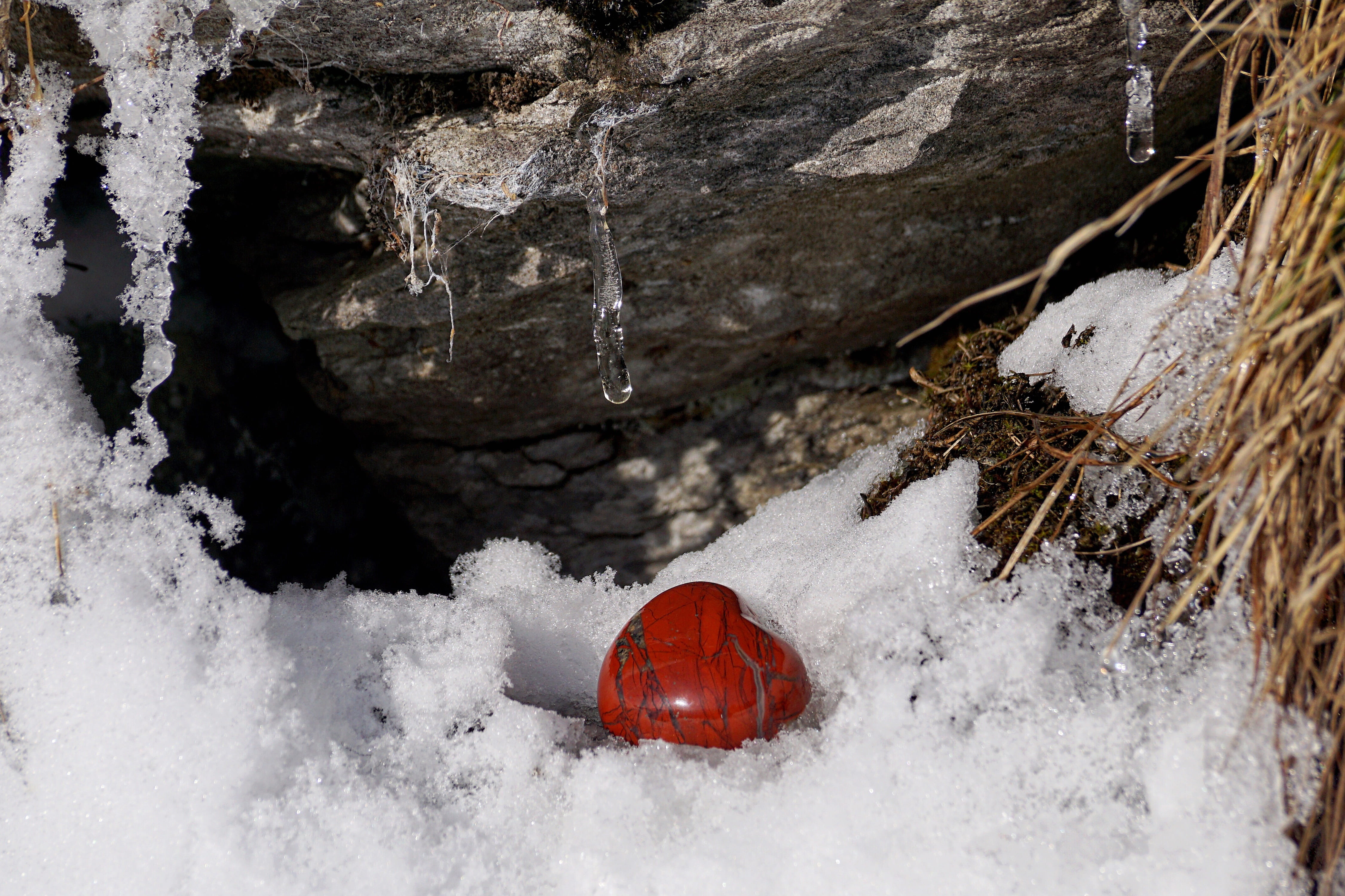 heart-shape red stone surrounded by ice, winter, snow, cold, nature