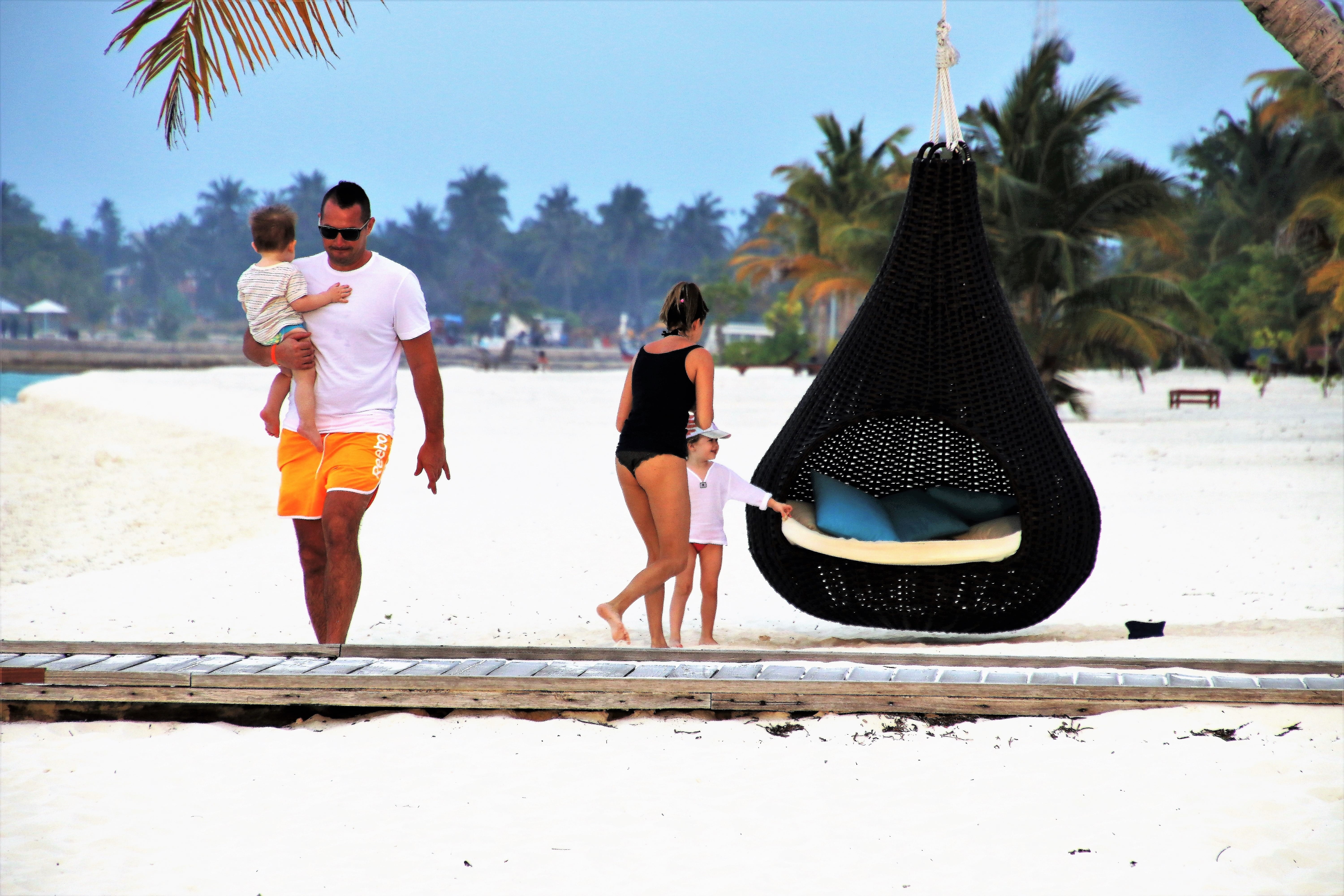 girl and woman standing near egg hanging chair, family, maldives