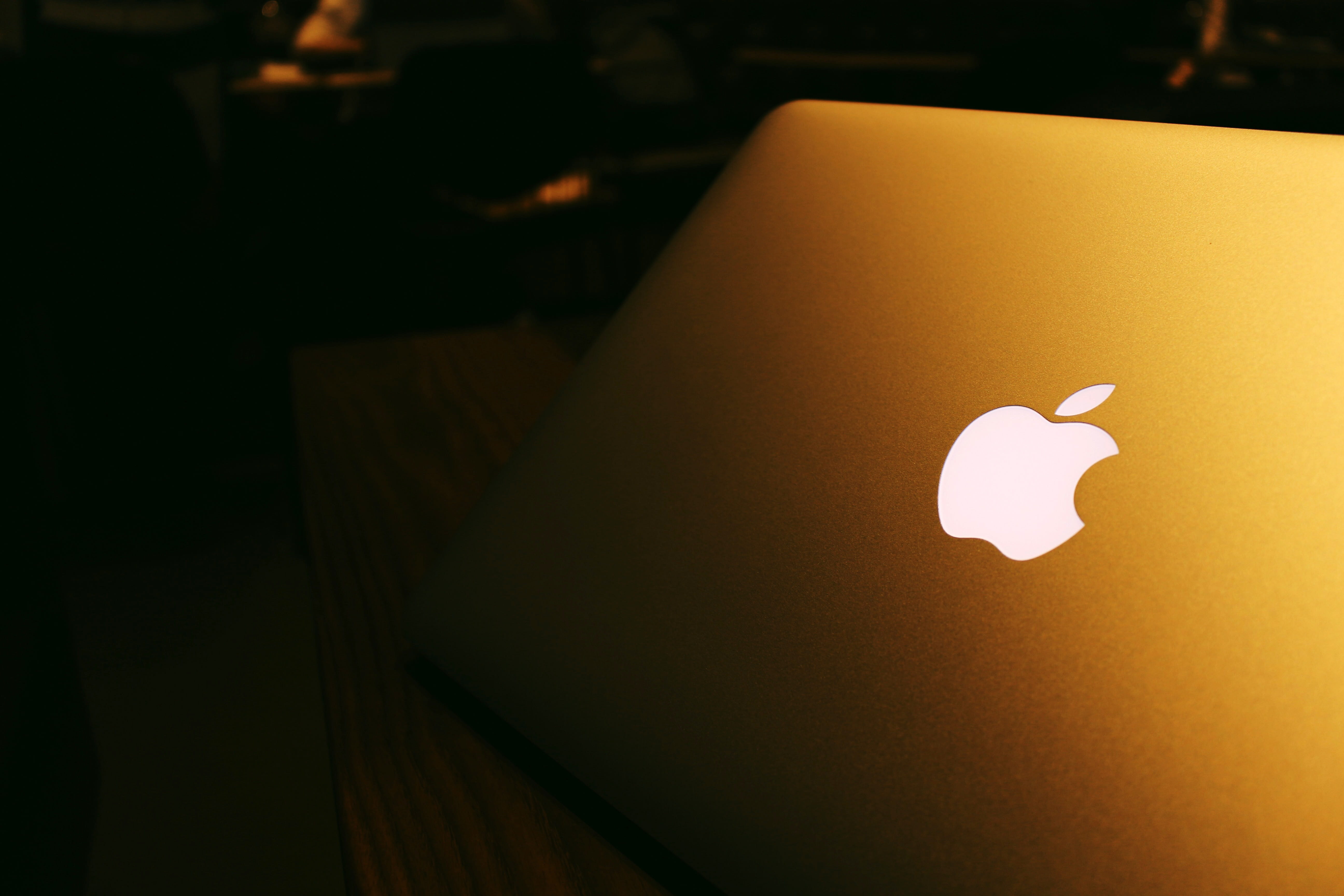 Macbook Pro at night with apple logo, lighted, public domain