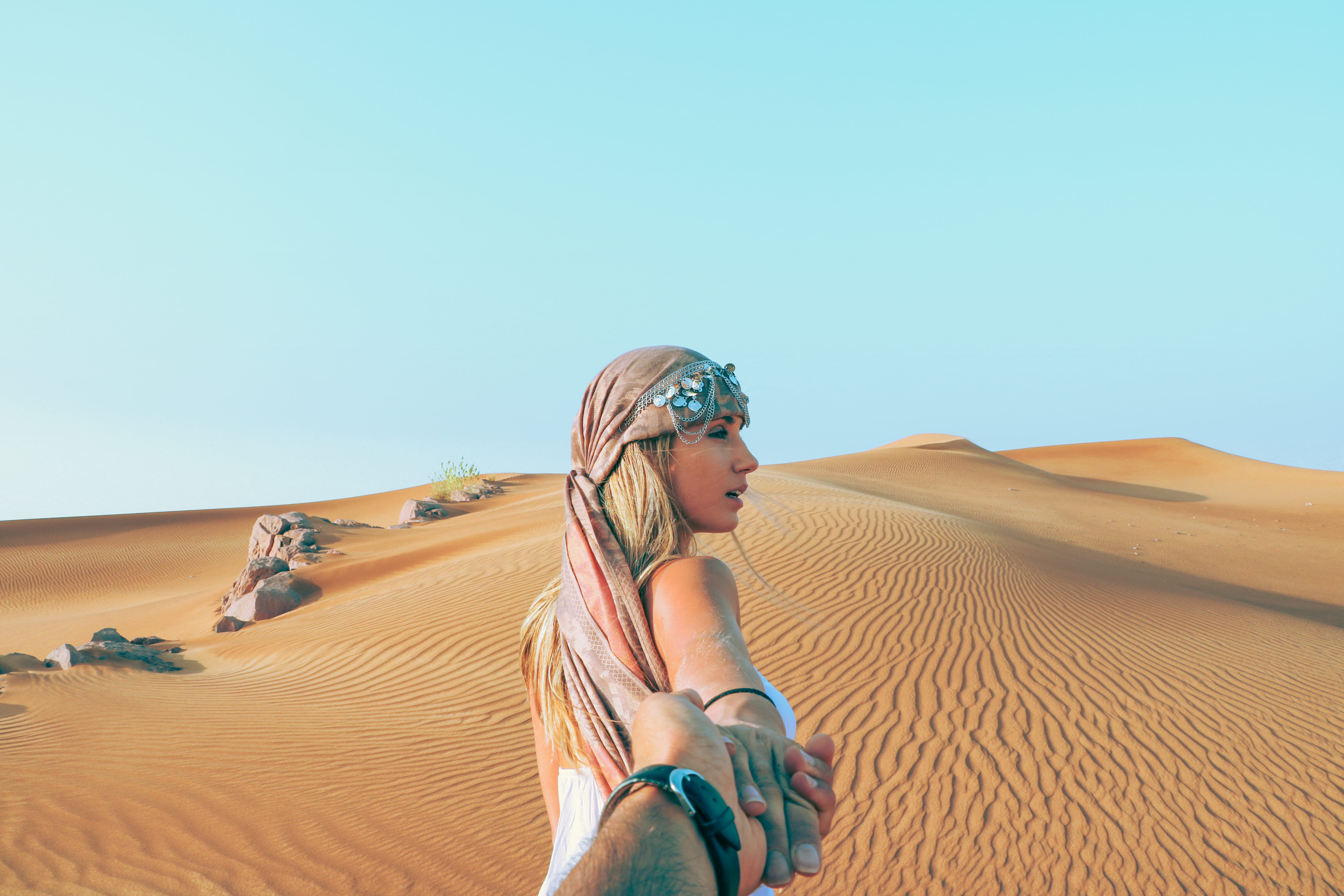 man and woman holding hands while in desert, relationship goals on desert
