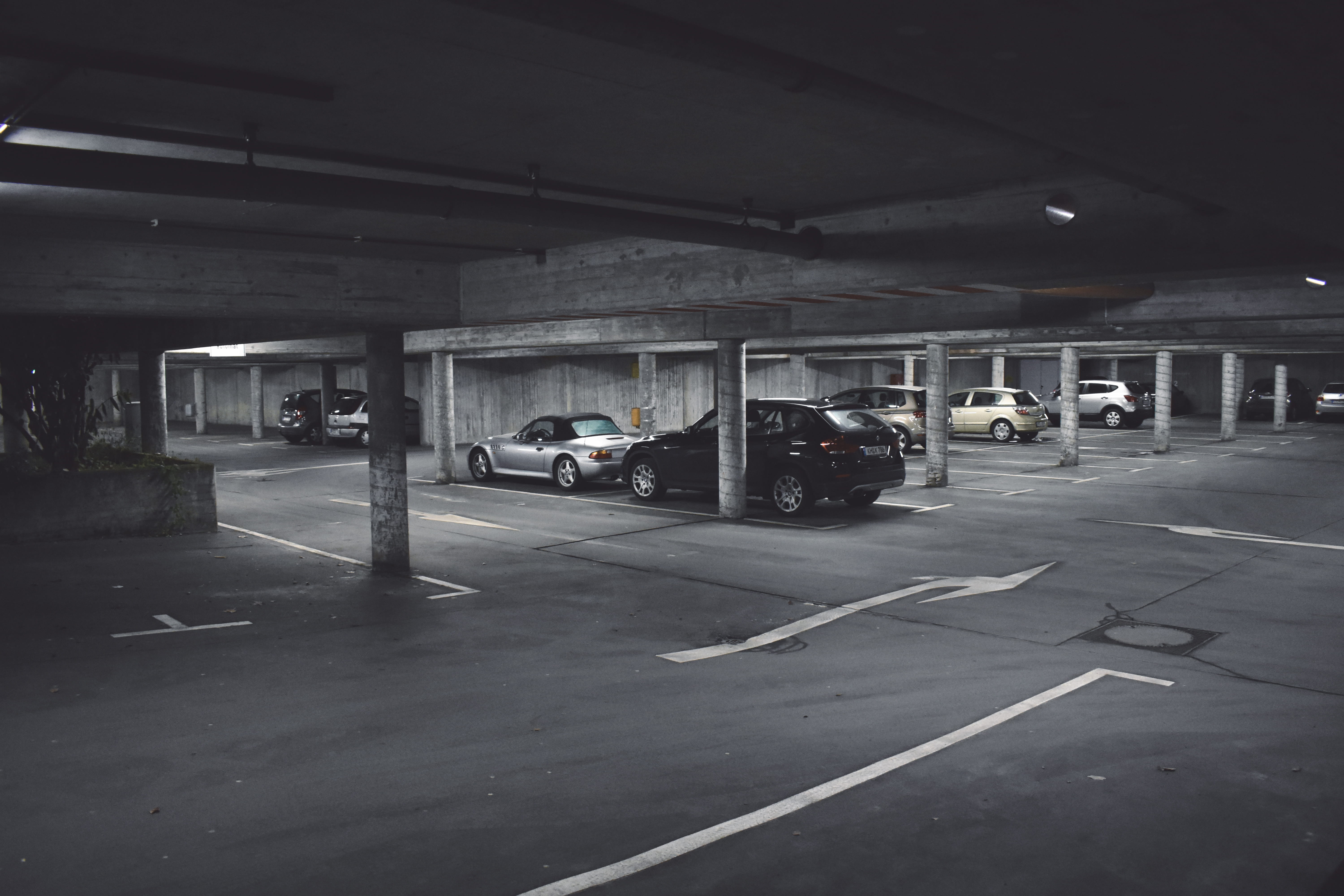 cars parked on parking area, grayscale photography of parked cars