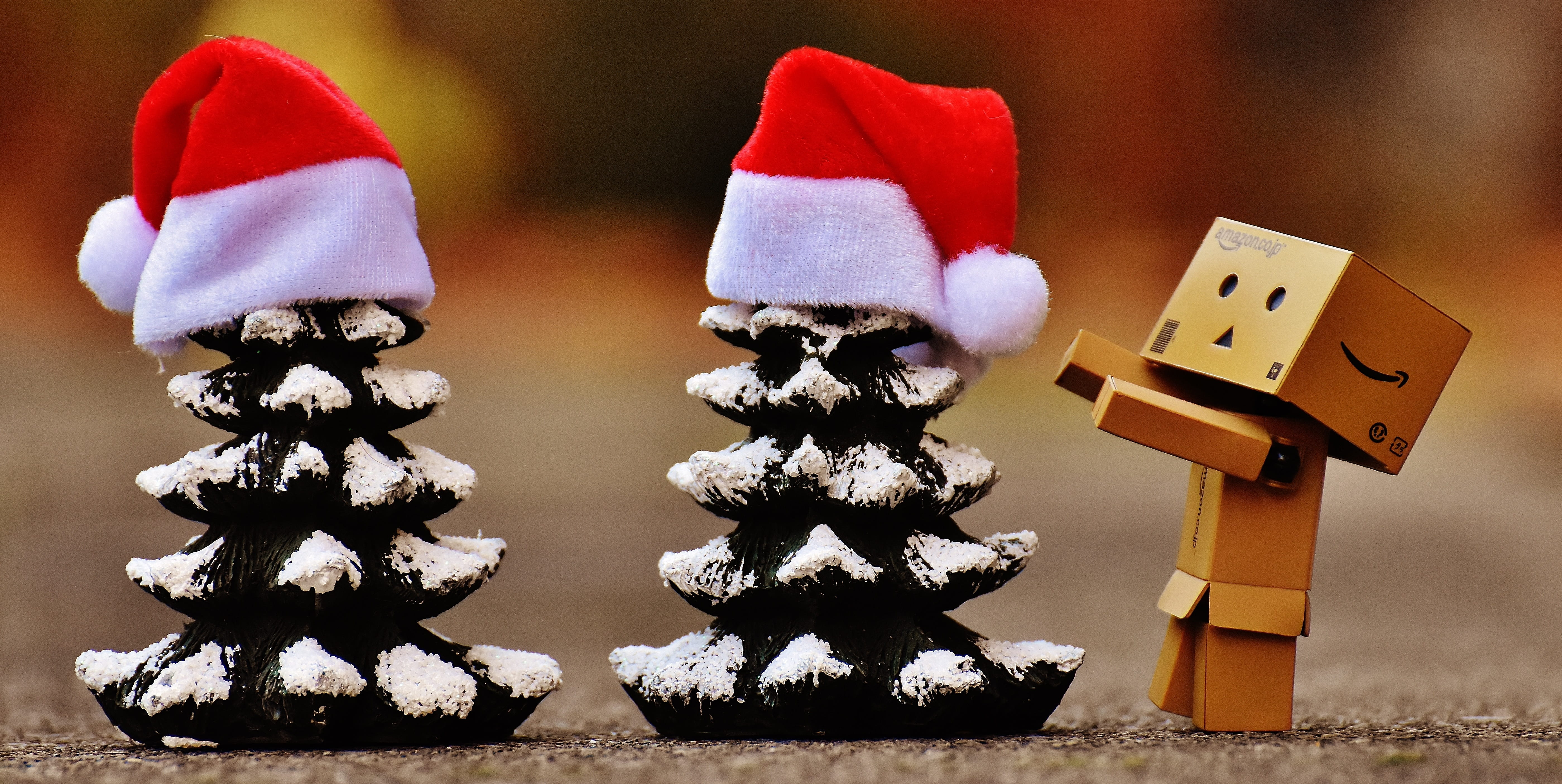 closeup photo of box figurine near the mini Christmas trees, Danbo