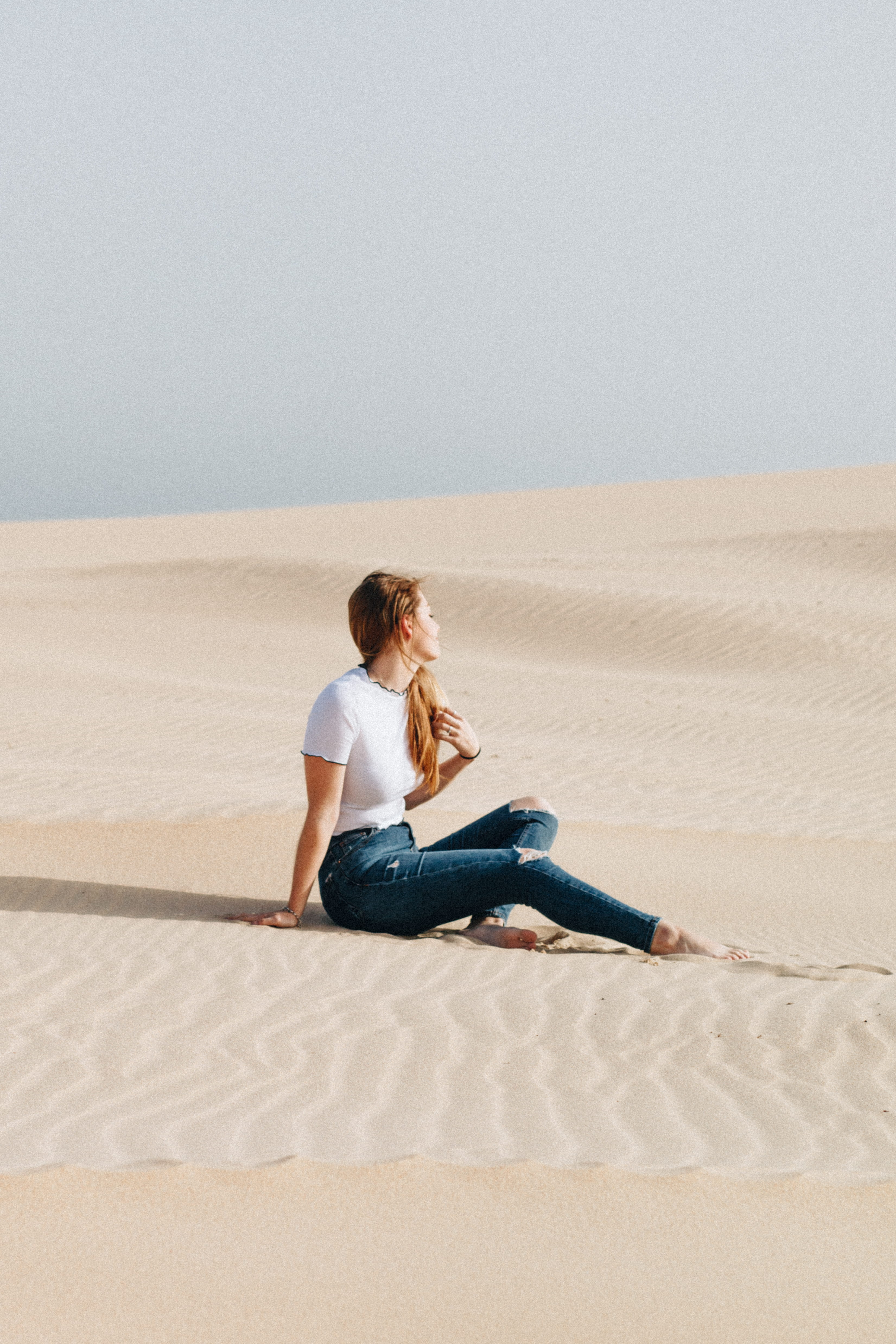 woman sitting on desert at daytime, woman sitting on the desert