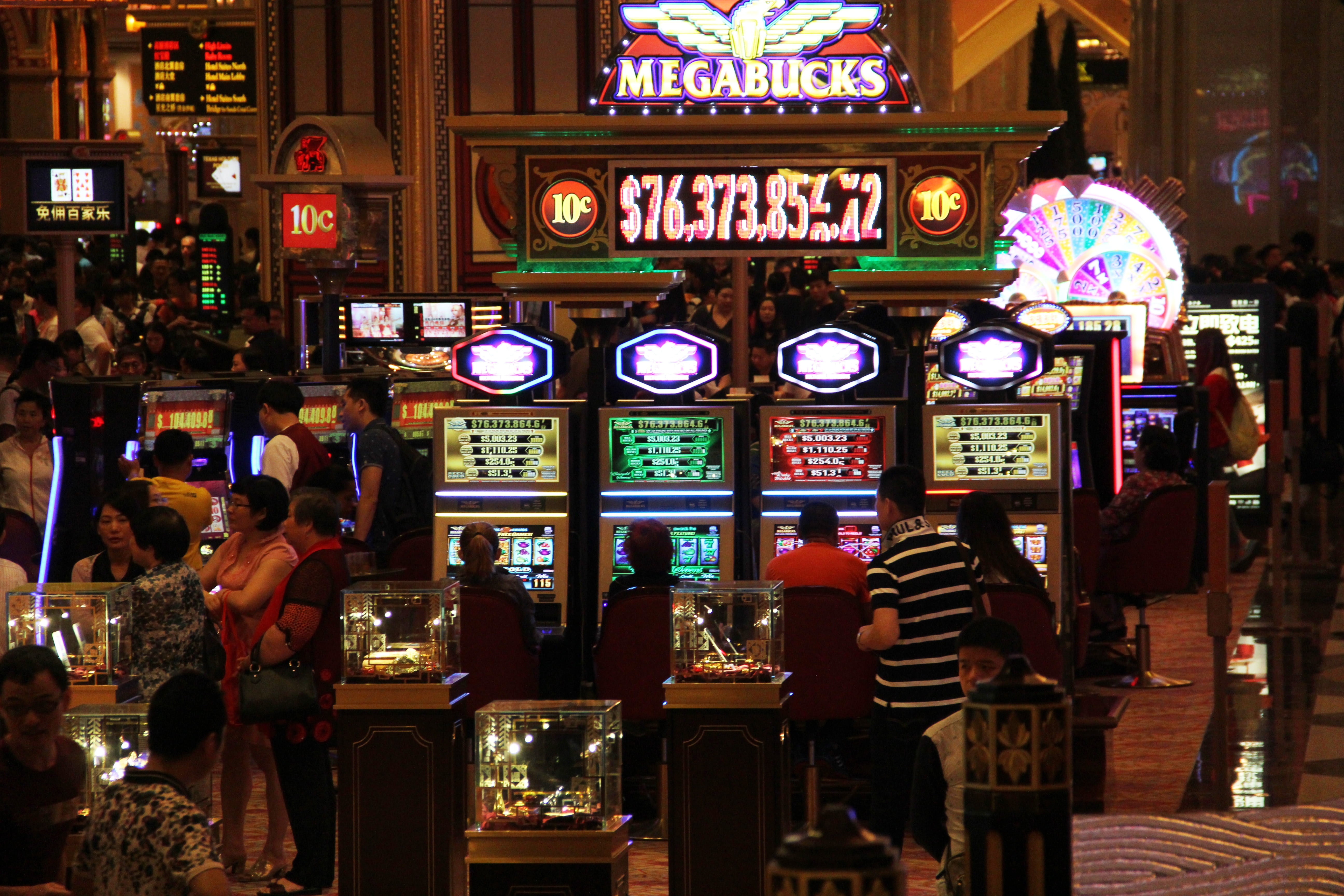 man walking in front of slot machines, casino, entertainment