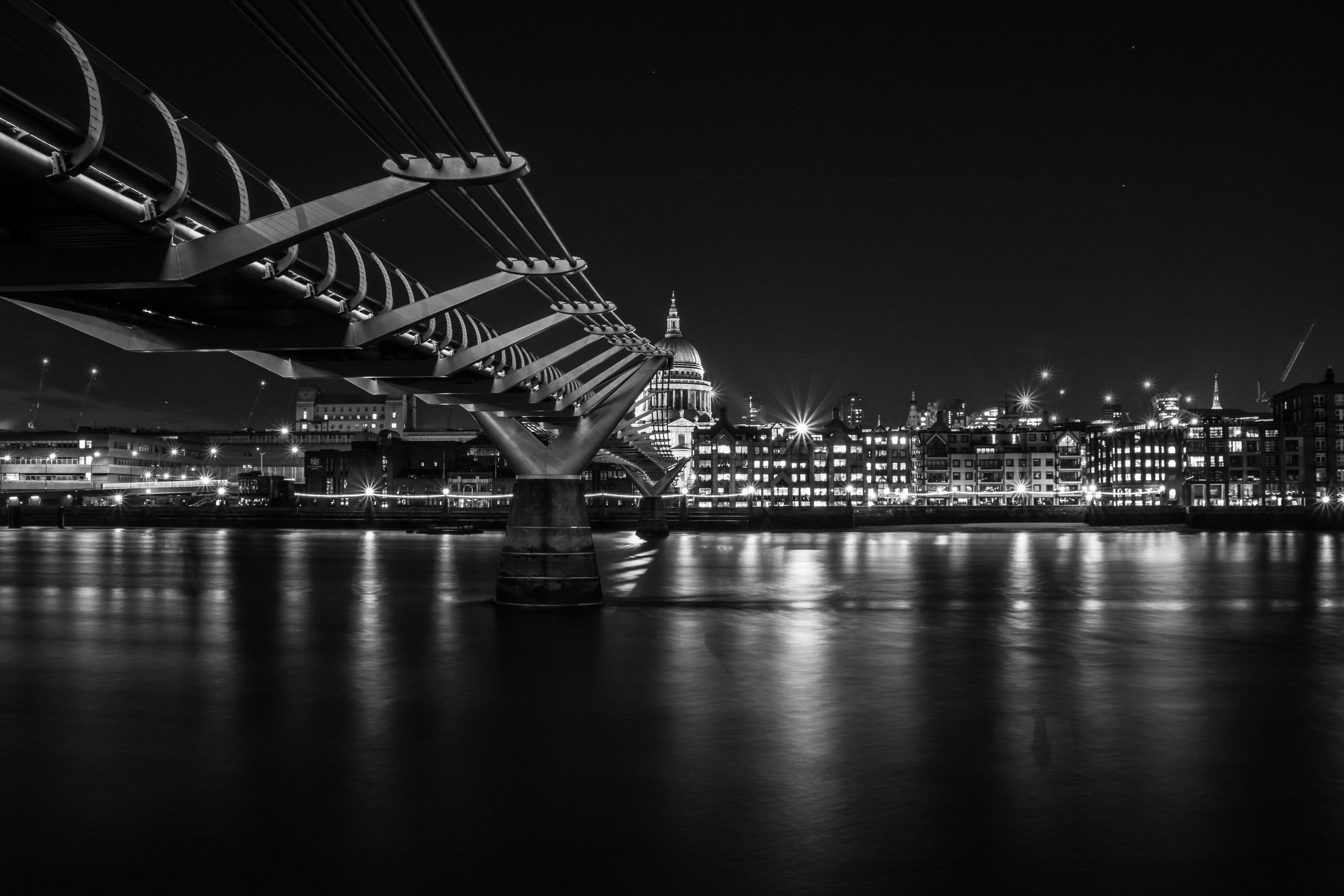 grayscale photo of bridge near cityscape, millennium, london