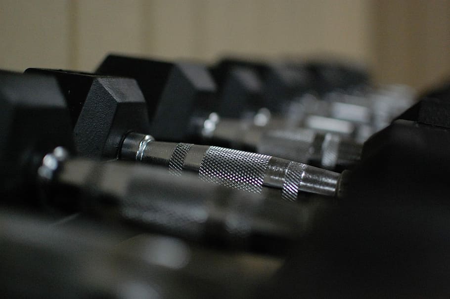 selective focus photography of inline black fixed-weight dumbbells HD wallpaper