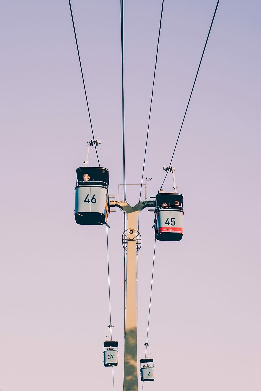 four black-and-gray cable cars crossing, low-angle photography of two cable cars HD wallpaper