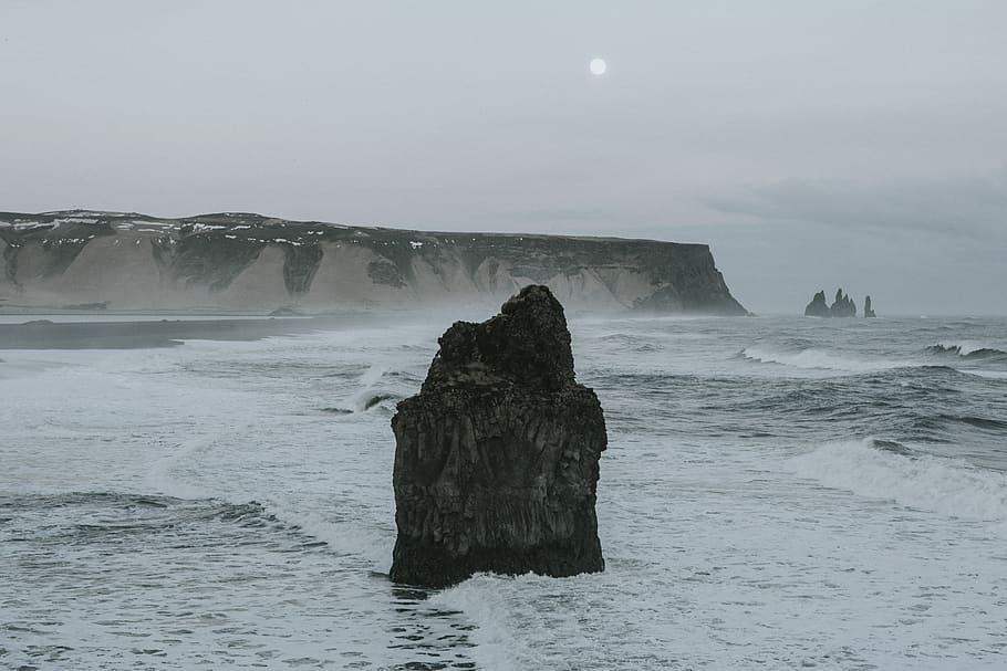 photography of brown rock formation on body of water during daytime, black rock formation at sea HD wallpaper