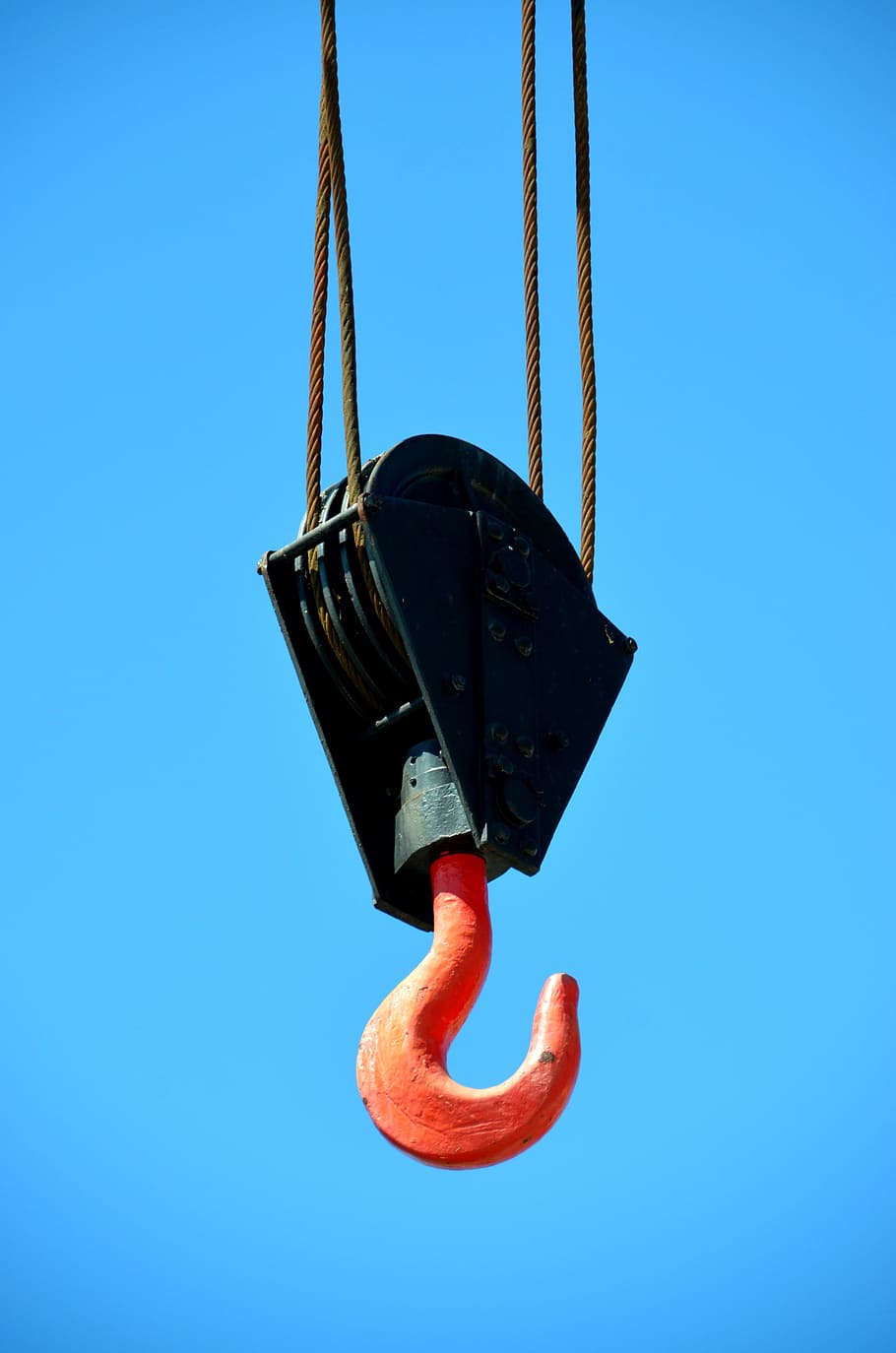 low-angle photography of black and orange pulley with hook, Crane