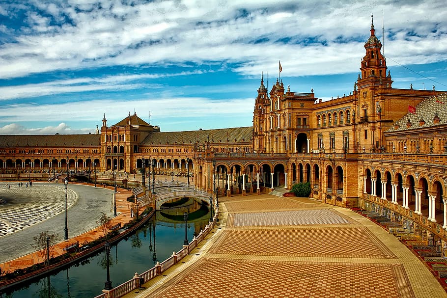 brown building near body of water, plaza espana, seville, spain