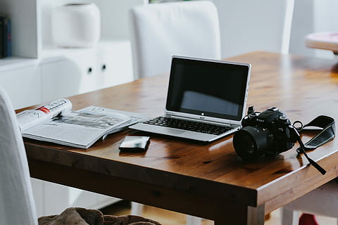 Silver laptop with various items on a table, magazines, computer HD wallpaper