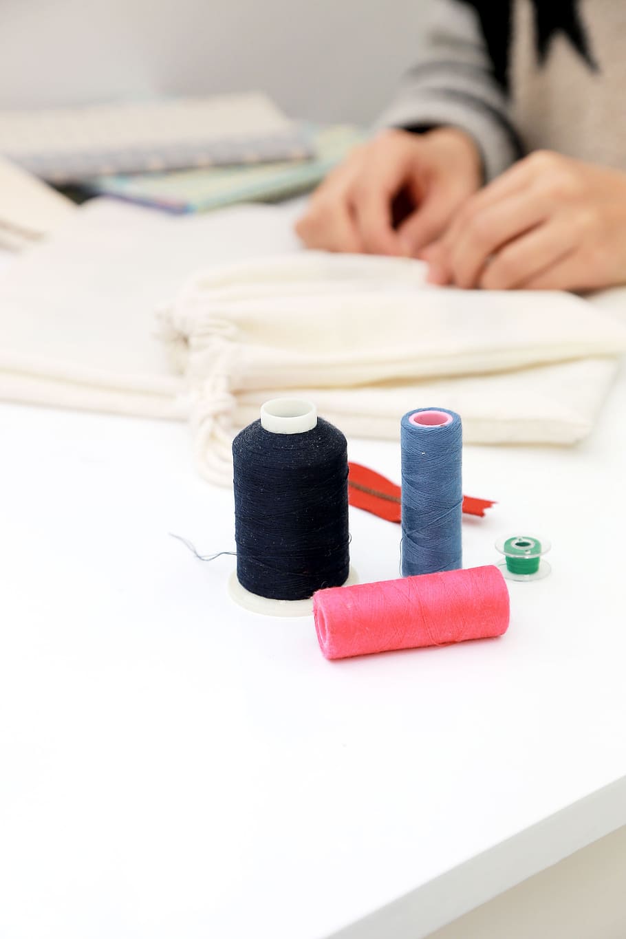 three assorted-color thread spools on white table, sewing, sewing machine HD wallpaper