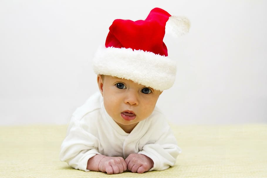 baby wearing red Santa hat crawling on floor, christmas, boy