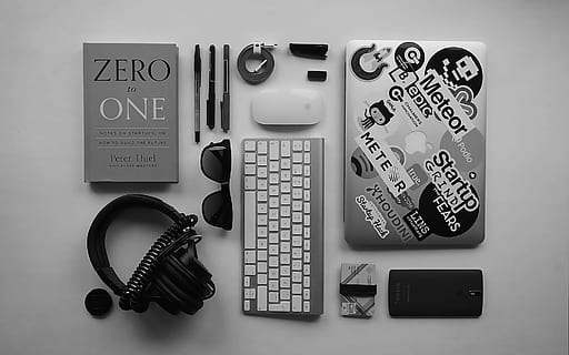 black corded headphones, silver MacBook, Apple wireless keyboard, and Apple Magic Mouse, zero one book besides pens and Apple Magic keyboard HD wallpaper