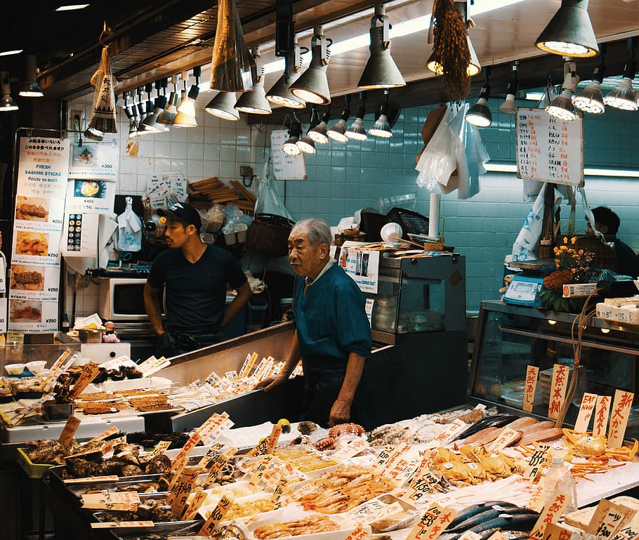 man standing beside table, fish market, seafood, fish stall, fishmonger, HD wallpaper