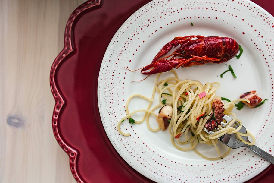 Fancy dinner with seafood pasta, crayfish and red wine by the table decorated with roses HD wallpaper
