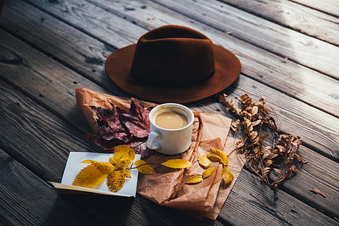 white ceramic coffee mug beside cowboy hat, cup of coffee beside brown hat and yellow leaves HD wallpaper