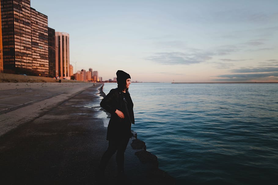 woman beside body of water at daytime, wearing, black, jacket HD wallpaper