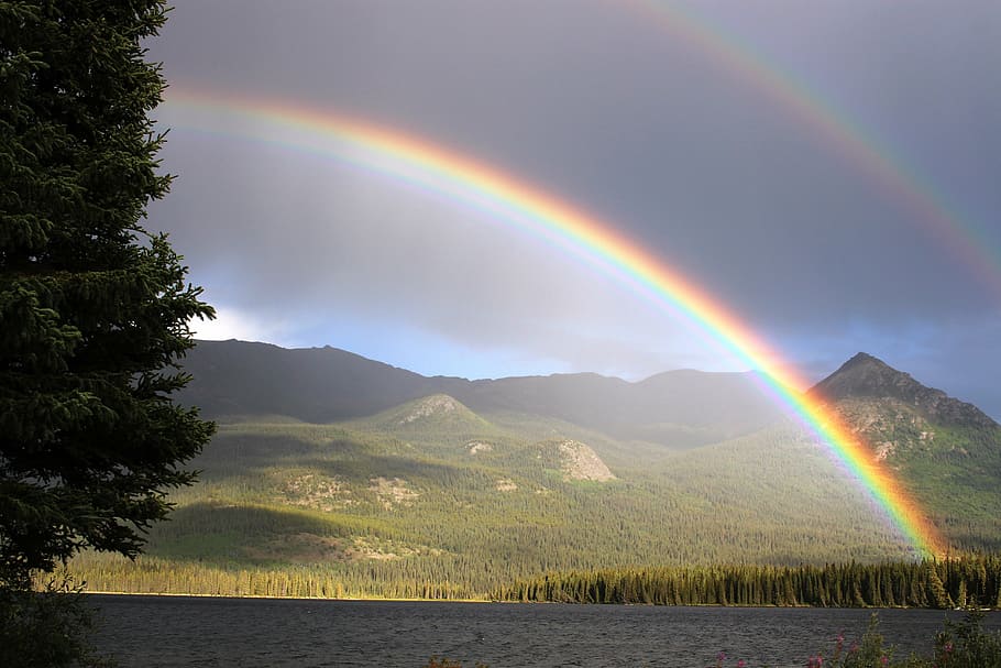 photo of green mountains, rainbow, arch, palmer lake, atlin, rainbow colors