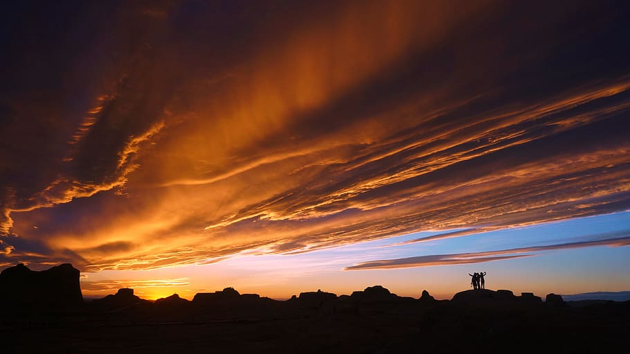 silhouette of trees during orange sunset, silhouette of hills under cloudy sky during golden hour HD wallpaper